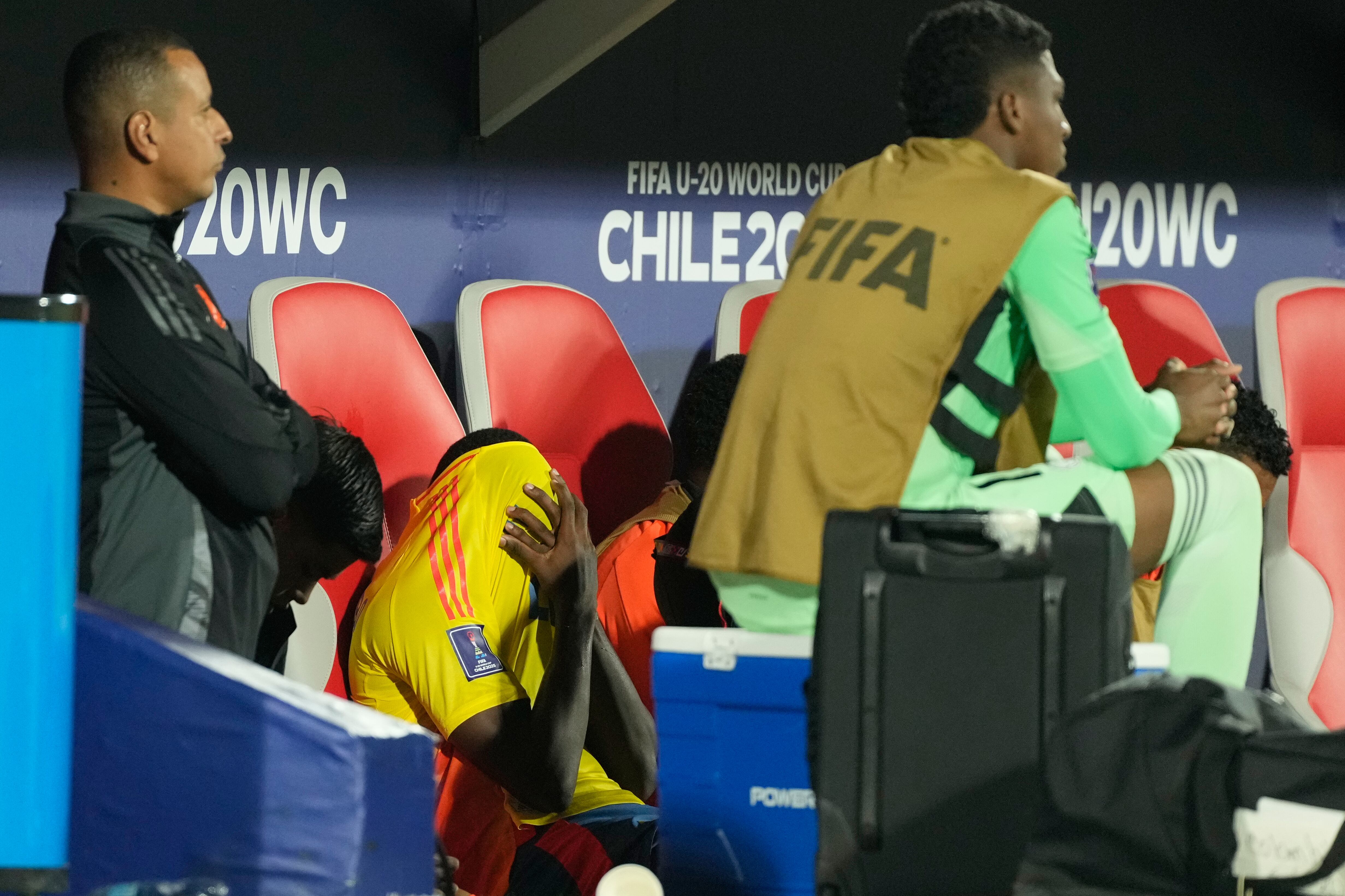 Colombia's Joel Canchimbo covers his face after leaving the field with an injury during a FIFA U-20 World Cup semifinal soccer match against Argentina at National Stadium in Santiago, Chile, Wednesday, Oct. 15, 2025.(AP Photo/Gustavo Garello)