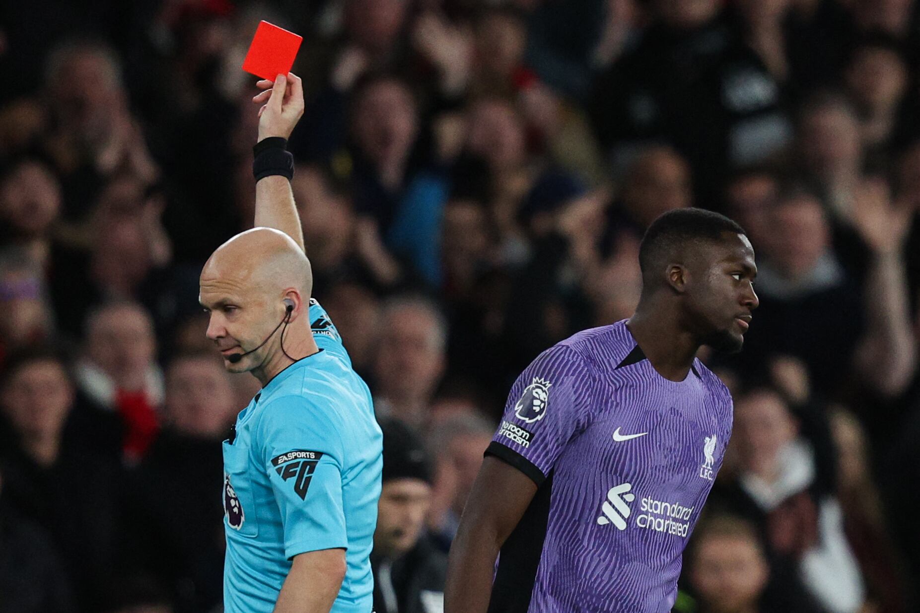 Referee Anthony Taylor shows a red card to Liverpool's French defender #05 Ibrahima Konate during the English Premier League football match between Arsenal and Liverpool at the Emirates Stadium in London on February 4, 2024. (Photo by Adrian DENNIS / AFP) / RESTRICTED TO EDITORIAL USE. No use with unauthorized audio, video, data, fixture lists, club/league logos or 'live' services. Online in-match use limited to 120 images. An additional 40 images may be used in extra time. No video emulation. Social media in-match use limited to 120 images. An additional 40 images may be used in extra time. No use in betting publications, games or single club/league/player publications. /