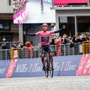 Overall leader Team Ineos rider Colombia's Egan Bernal celebrates as he crosses the finish line to win the 16th stage of the Giro d'Italia 2021 cycling race, 153km between Sacile and Cortina d'Ampezzo on May 24, 2021. (Photo by Luca BETTINI / AFP)