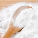 Baking soda with wooden spoon.