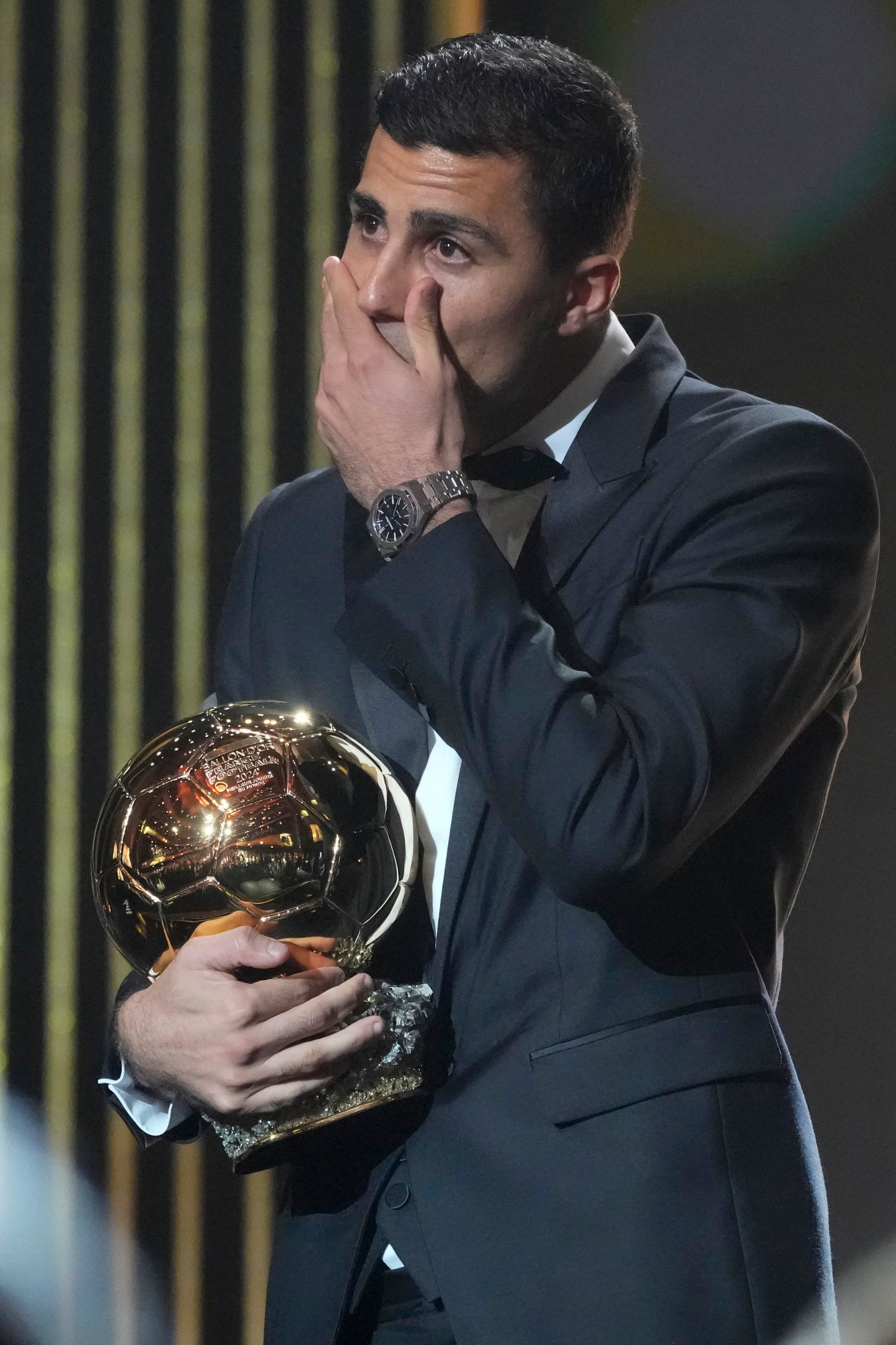 Manchester City's Spanish player Rodri gets emotional as he receives the 2024 Men's Ballon d'Or award during the 68th Ballon d'Or (Golden Ball) award ceremony at Theatre du Chatelet in Paris, Monday, Oct. 28, 2024. (AP Photo/Michel Euler)