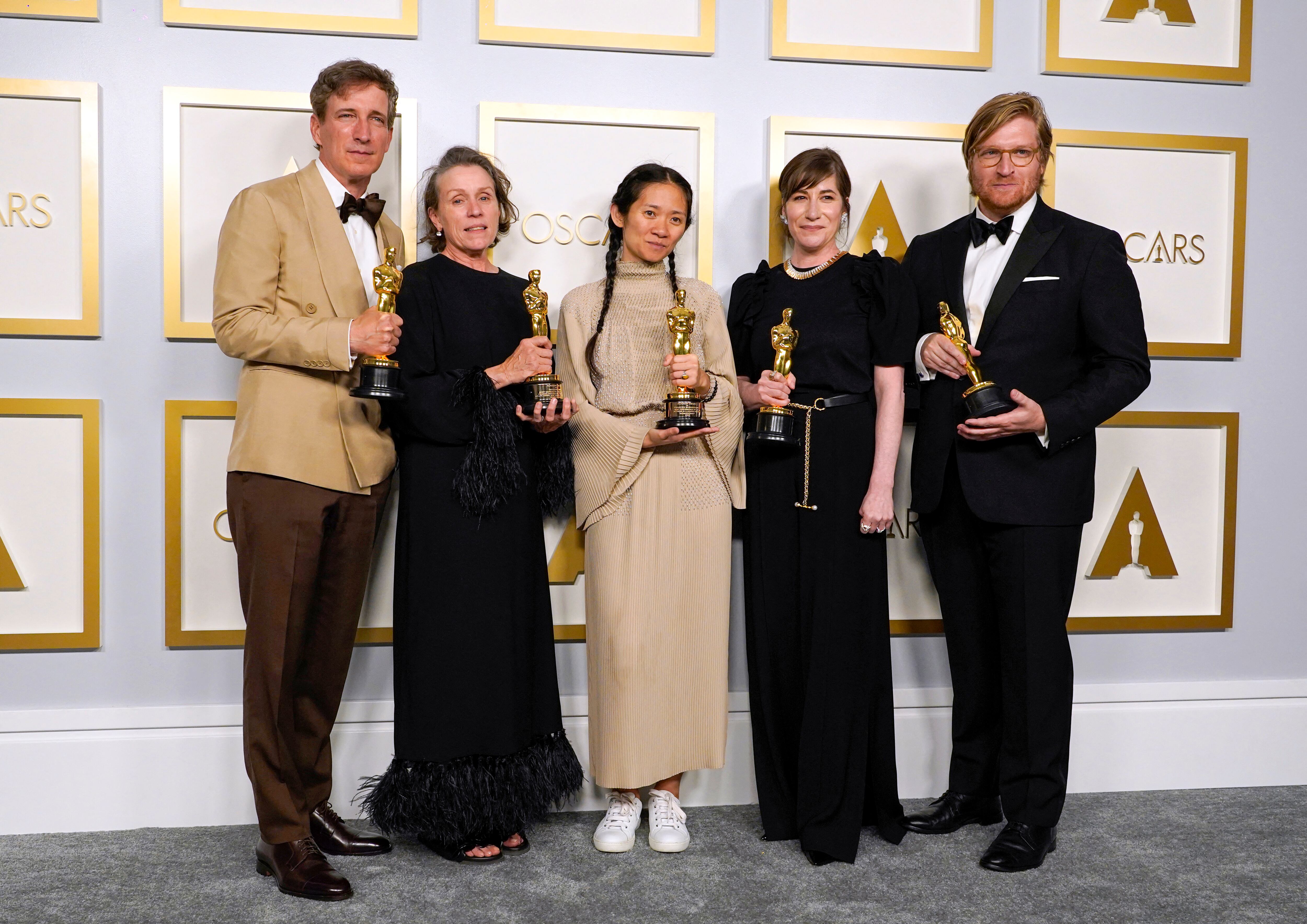 Zhao con Peter Spears, Frances McDormand, Mollye Asher y Dan Janvey, sus compañeros en Nomadland, luego de ser galardonados por la cinta.