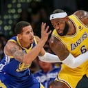 Los Angeles Lakers forward LeBron James, right, is defended by Golden State Warriors forward Juan Toscano-Anderson during the second half of a preseason NBA basketball game in Los Angeles, Tuesday, Oct. 12, 2021. (AP Photo/Ringo H.W. Chiu)