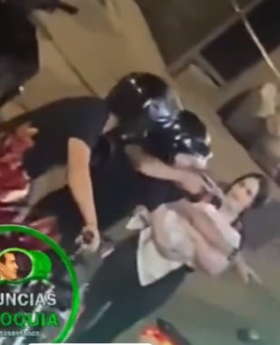 Uno de los hombres amenaza con arma de fuego a la víctima antes de huir en una moto.