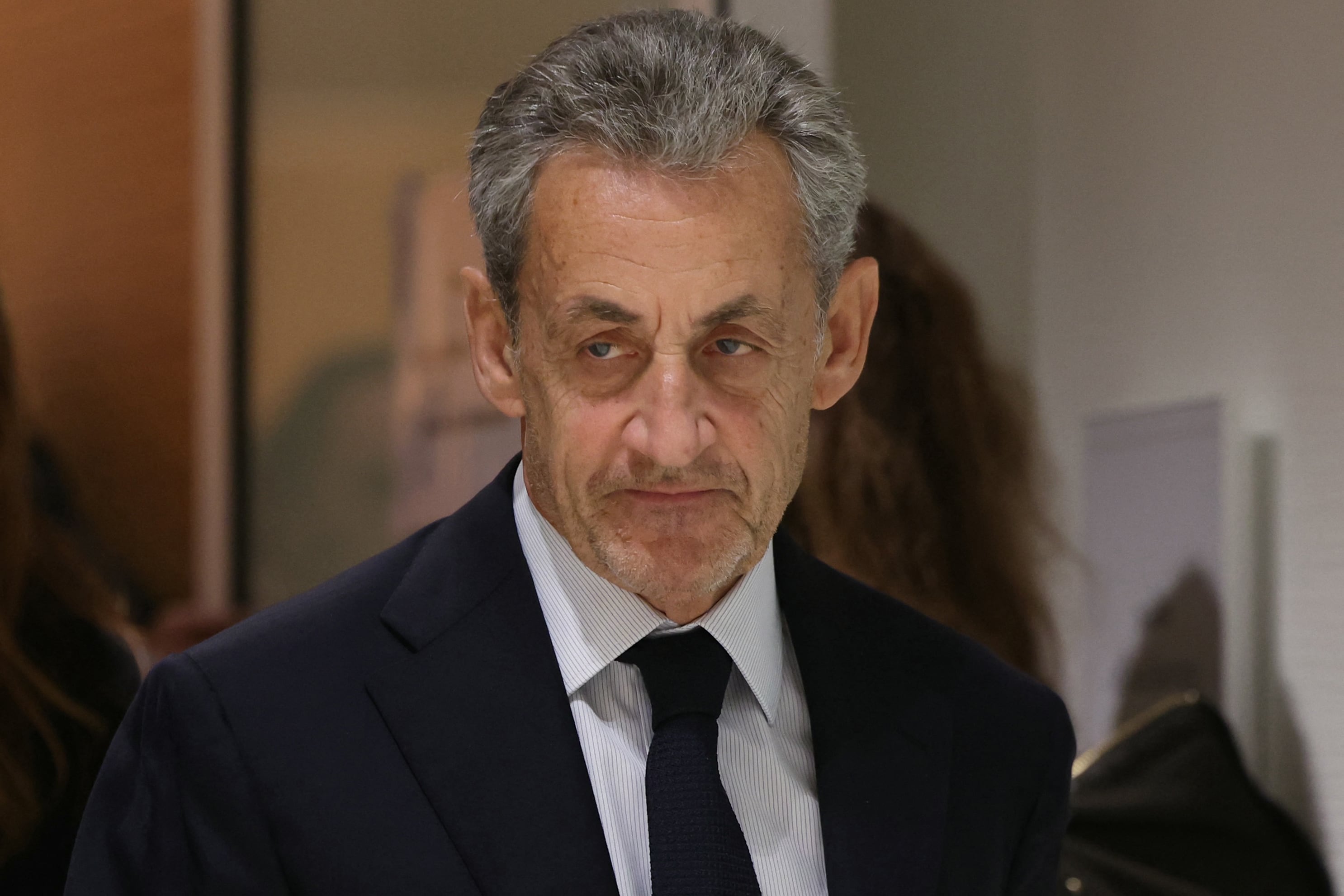 Former French president Nicolas Sarkozy leaves after the verdict in his trial for illegal campaign financing from Libya for his successful 2007 presidential bid, at the Tribunal de Paris courthouse in Paris, on September 25, 2025. A Paris court on September 25, 2025 sentenced former French president Nicolas Sarkozy to five years and ordered him to go to prison after finding him guilty of criminal conspiracy over accusations the late Libyan dictator Moamer Kadhafi helped fund his victorious 2007 presidential run. The court ordered that Sarkozy should be placed in custody at a later date, with prosecutors given one month to inform the former head of state when he should go to prison. (Photo by Alain JOCARD / AFP)