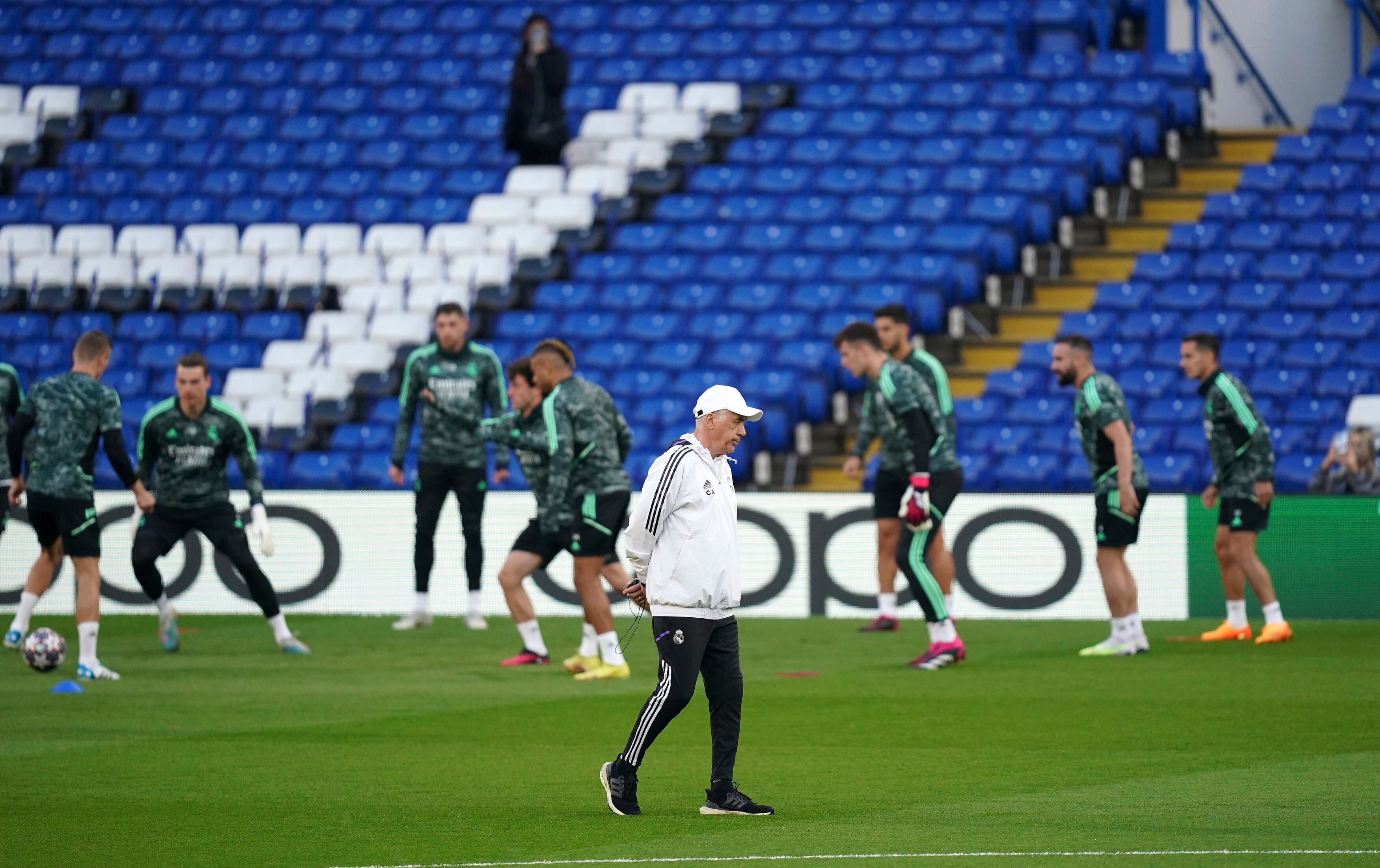 Real Madrid manager Carlo Ancelotti, foreground, walks with the players on the background during a training session at Stamford Bridge, the day ahead of their UEFA Champions League quarterfinal soccer match against Chelsea FC, in London, Monday April 17, 2023. (John Walton/PA via AP)