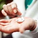 Senior woman holding pills selection in her hands, close-up.