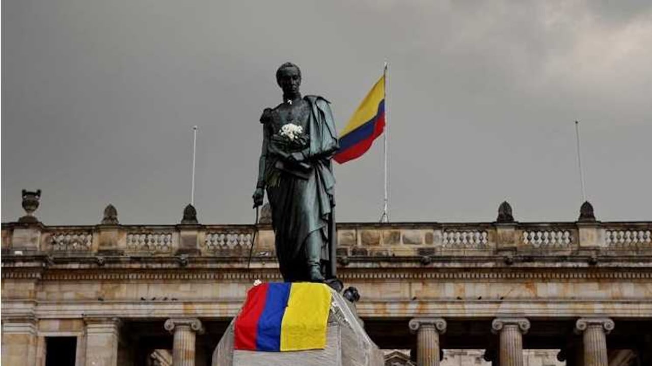 La estatua de Simón Bolívar este viernes, 7 de octubre de 2016, en la Plaza de Bolívar de Bogotá. Habitantes de Bogotá celebran con flores blancas y banderas de Colombia el Premio Nobel ganado por el presidente Juan Manuel Santos. EFE