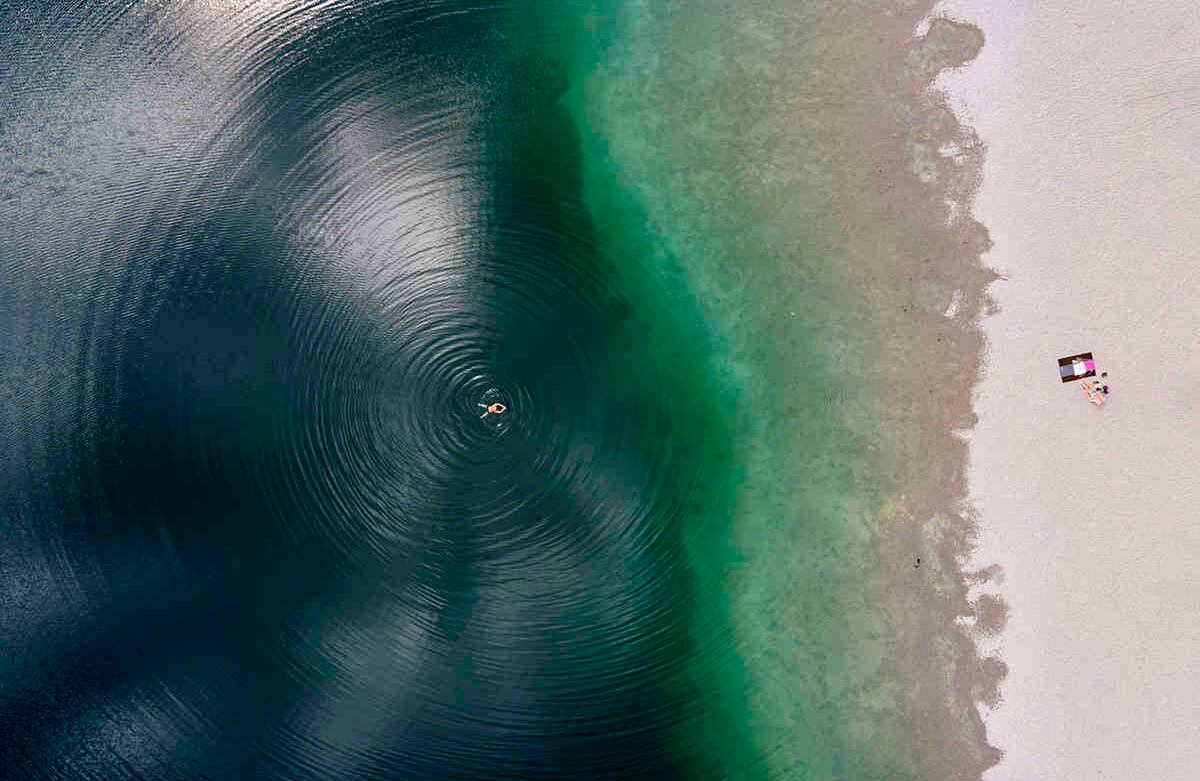 En esta foto, tomada con un dron, un hombre y una mujer disfrutan del hermoso clima en el  lago Langwieder,  en Munich, Alemania, el 18 de junio. Foto: Sven Hoppe / dpa a través de AP
