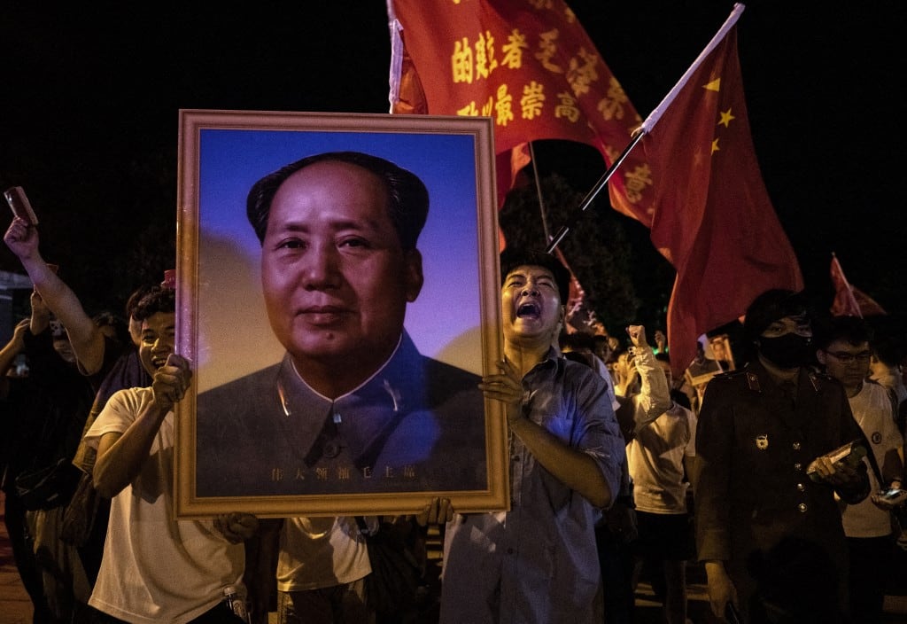 SHAOSHAN, CHINA - 8 DE SEPTIEMBRE: Varias personas portan una fotografía del fallecido líder chino Mao Zedong mientras le rinden homenaje frente a una estatua de bronce suya, poco antes del inicio del 50.º aniversario de su muerte, al final de la jornada del 8 de septiembre de 2026, en su ciudad natal de Shaoshan, provincia de Hunan, China. Mao, revolucionario comunista chino y fundador de la República Popular China, gobernó el país desde su fundación en 1949 hasta su muerte en 1976. (Foto de Kevin Frayer/Getty Images) (Foto de KEVIN FRAYER / GETTY IMAGES ASIAPAC / Getty Images vía AFP)