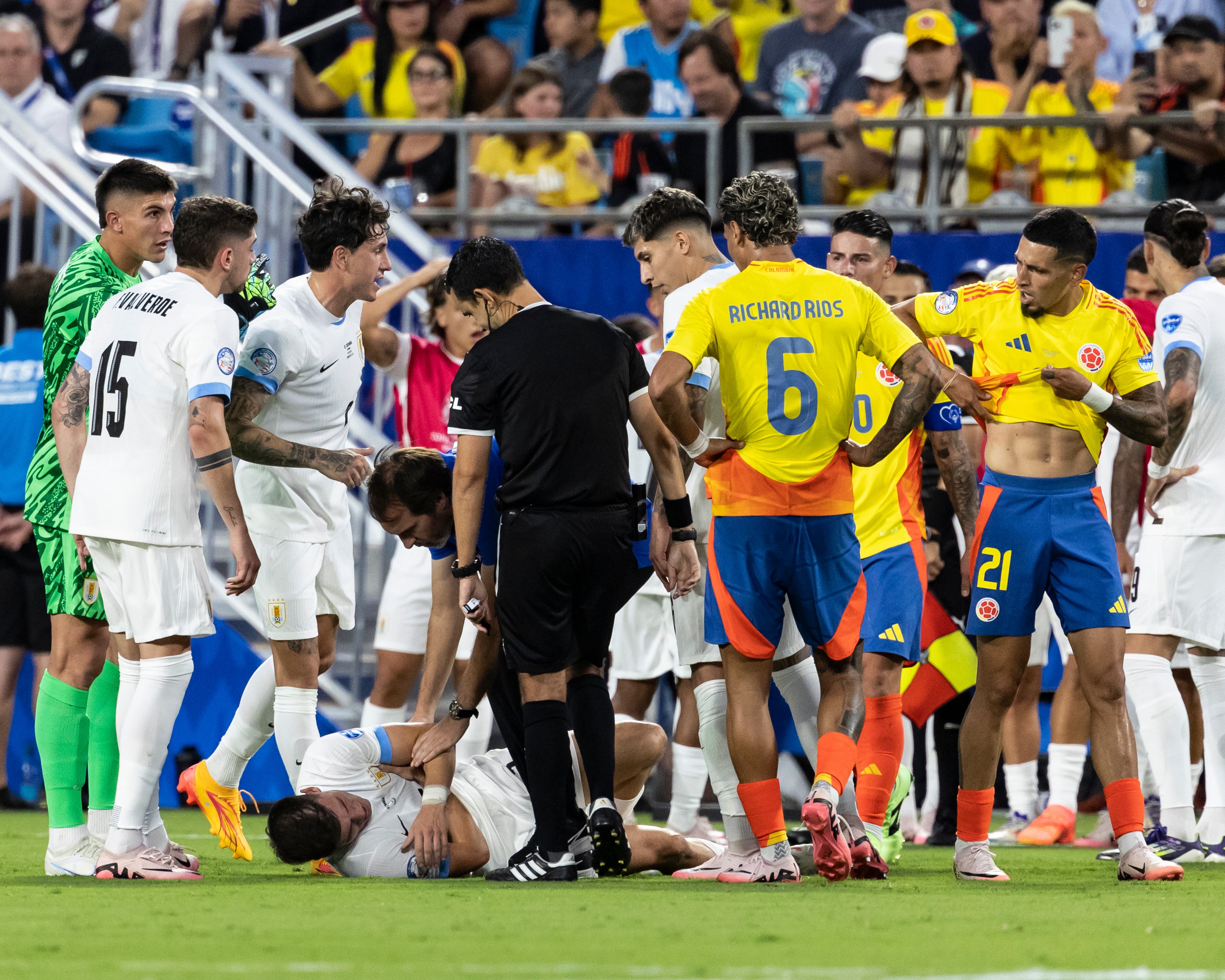 CHARLOTTE, NC - JULY 10: Manuel Ugarte #5 of Uruguay is on the ground after an elbow from Daniel Muñoz #21 of Colombia that resulted in his second yellow card and an expulsion during a game between Colombia and Uruguay at Bank of America Stadium on July 10, 2024 in Charlotte, North Carolina. (Photo by Steve Limentani/ISI Photos/Getty Images)