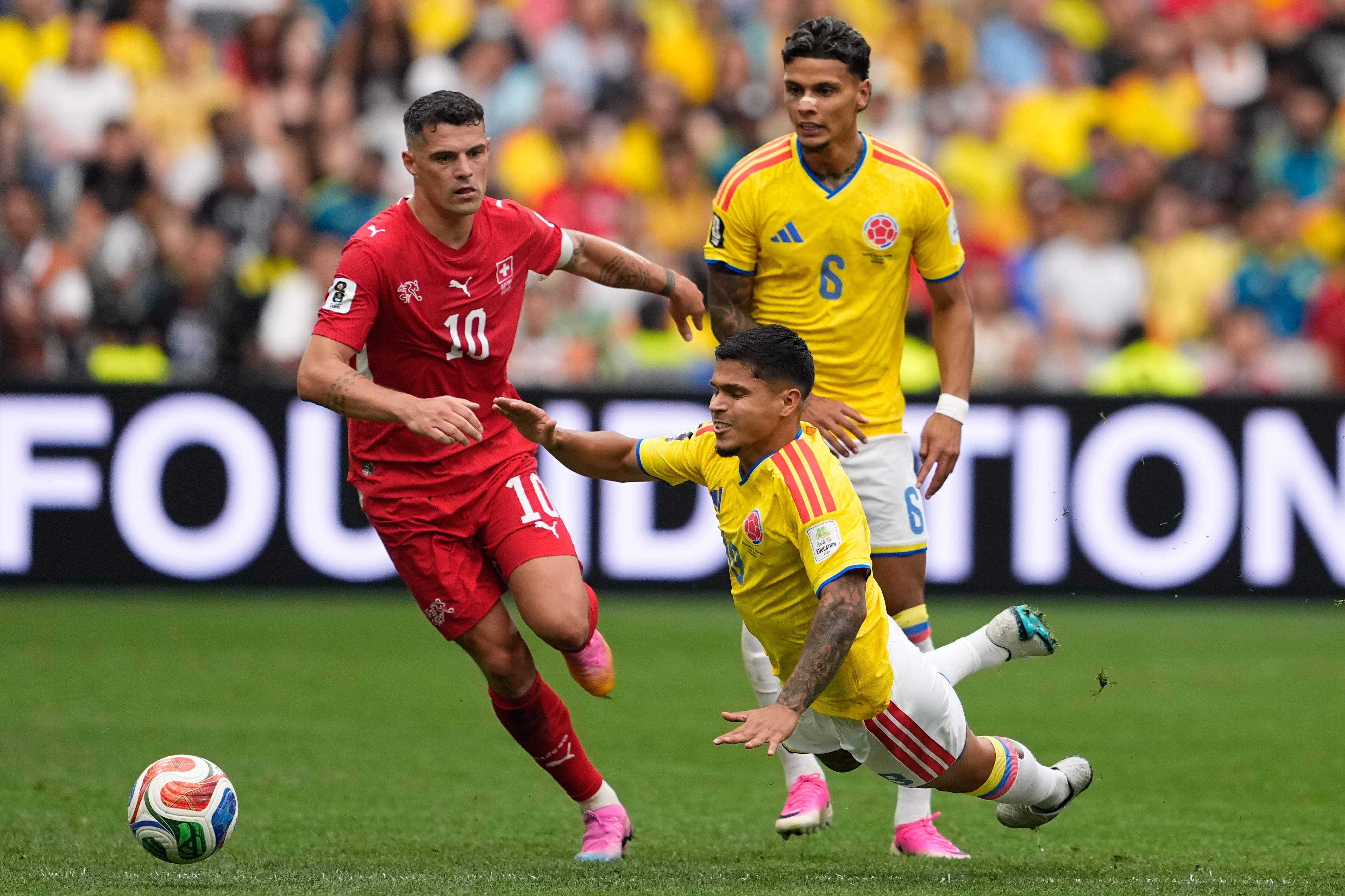 Colombia's Cucho Hernández (19) and Switzerland's Granit Xhaka (10) chase the ball during the World Cup round of 16 soccer match between Switzerland and Colombia in Vancouver, British Columbia, Tuesday, July 7, 2026. (AP Photo/Lindsey Wasson)