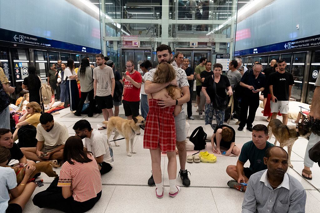 RAMAT GAN, ISRAEL - JUNE 18: People take cover in an underground train station transformed into a public shelter following reports of an incoming missile fired from Iran, on 18, 2025 in Ramat Gan, Israel. Iran launched a retaliatory missile strike on Israel starting late on June 13, after a series of Israeli airstrikes earlier in the day targeted Iranian military and nuclear sites, as well as top military officials. (Photo by Amir Levy/Getty Images)