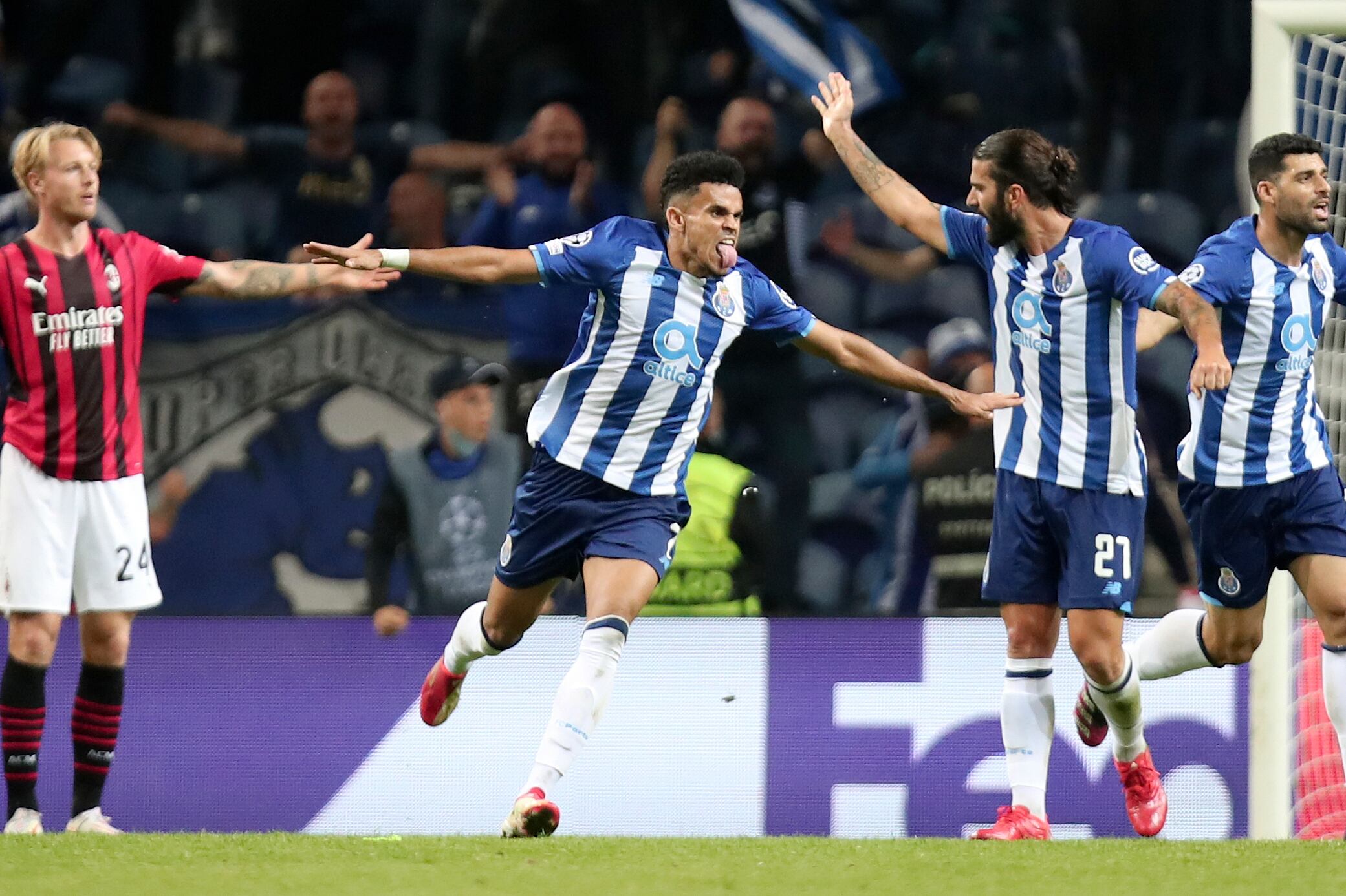 Porto's Luis Diaz, center, celebrates after scoring the opening goal during the Champions League group B soccer match between FC Porto and AC Milan at the Dragao stadium in Porto, Portugal, Tuesday, Oct. 19, 2021. (AP Photo/Luis Vieira)