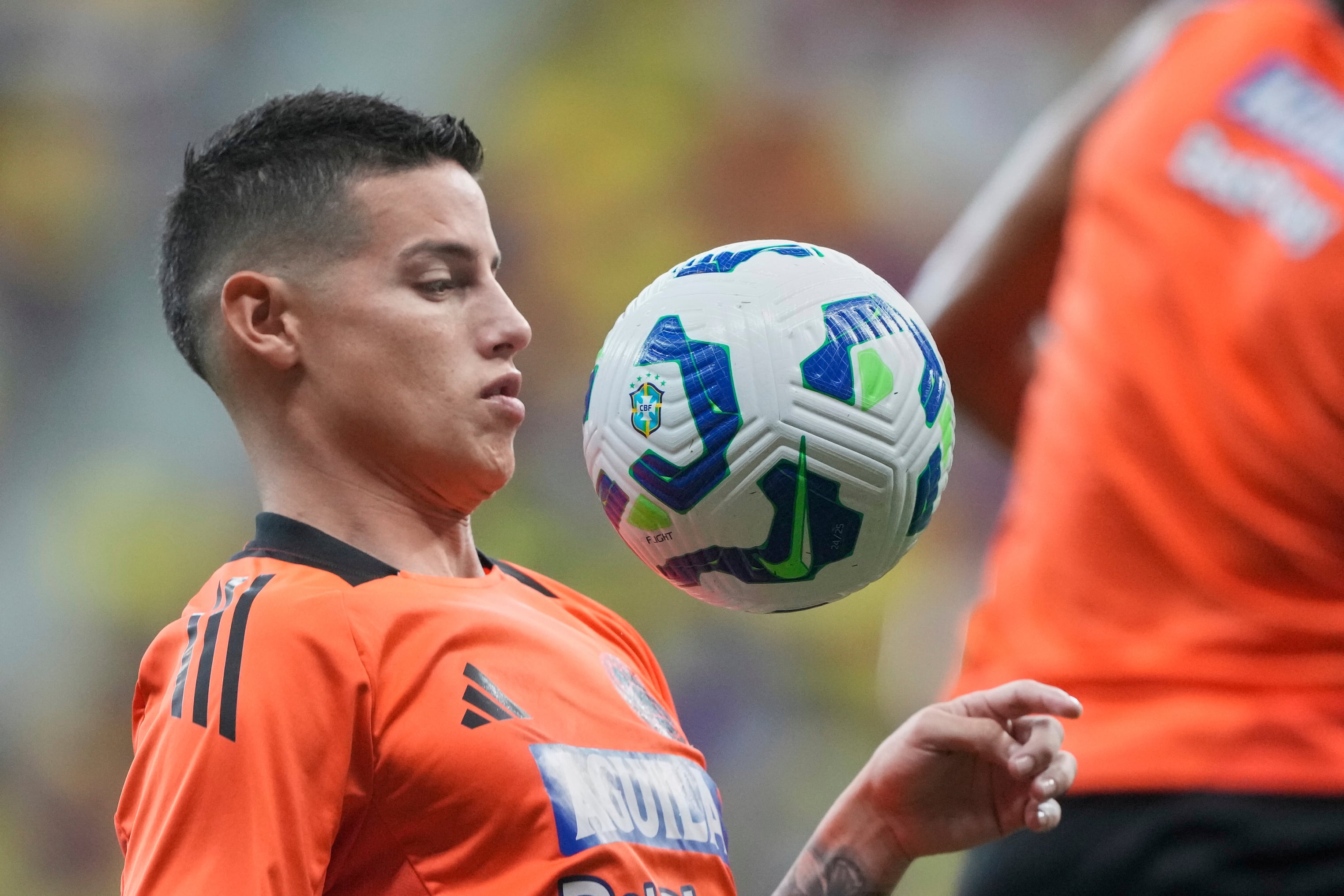 Colombia's Jamez Rodriguez warms up prior to a FIFA World Cup 2026 qualifying soccer match against Brazil at Mane Garrincha stadium in Brasilia, Brazil, Thursday, March 20, 2025. (AP Photo/Eraldo Peres)