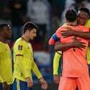 Colombia's Yerry Mina, right, embraces goalkeeper David Ospina at the end of a qualifying soccer match for the FIFA World Cup Qatar 2022 against Uruguay in Montevideo, Uruguay, Thursday, Oct. 7, 2021. The game ended in a 0-0 tie. (Andres Cuenca/Pool via AP)