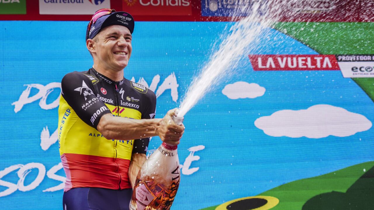 Belgium rider Remco Evenepoel of the Quick-Step Alpha Vinyl team celebrates at the podium after the individual time-trial stage of La Vuelta cycling race between Elche and Alicante, eastern Spain, Tuesday, Aug. 30, 2022. (AP/Alberto Saiz)