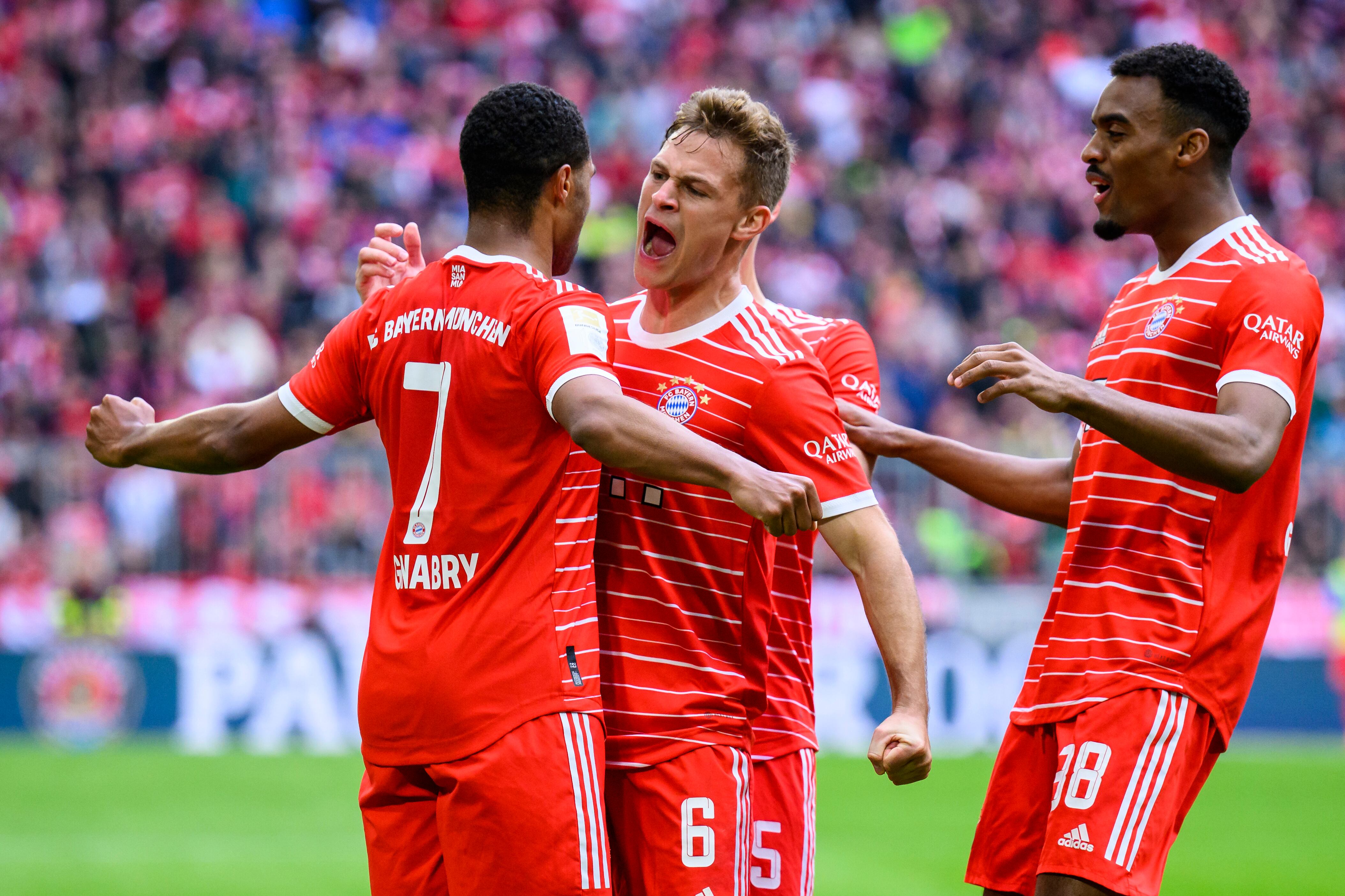 Munich's scorer Serge Gnabry, left, celebrates with his teammates Joshua Kimmich, center, and Ryan Gravenberch, right, celebrate their side's fourth goal during the German Bundesliga soccer match between FC Bayern Munich and FC Schalke 04 in Munich, Germany, Saturday, May 13, 2023. (Tom Weller/dpa via AP)