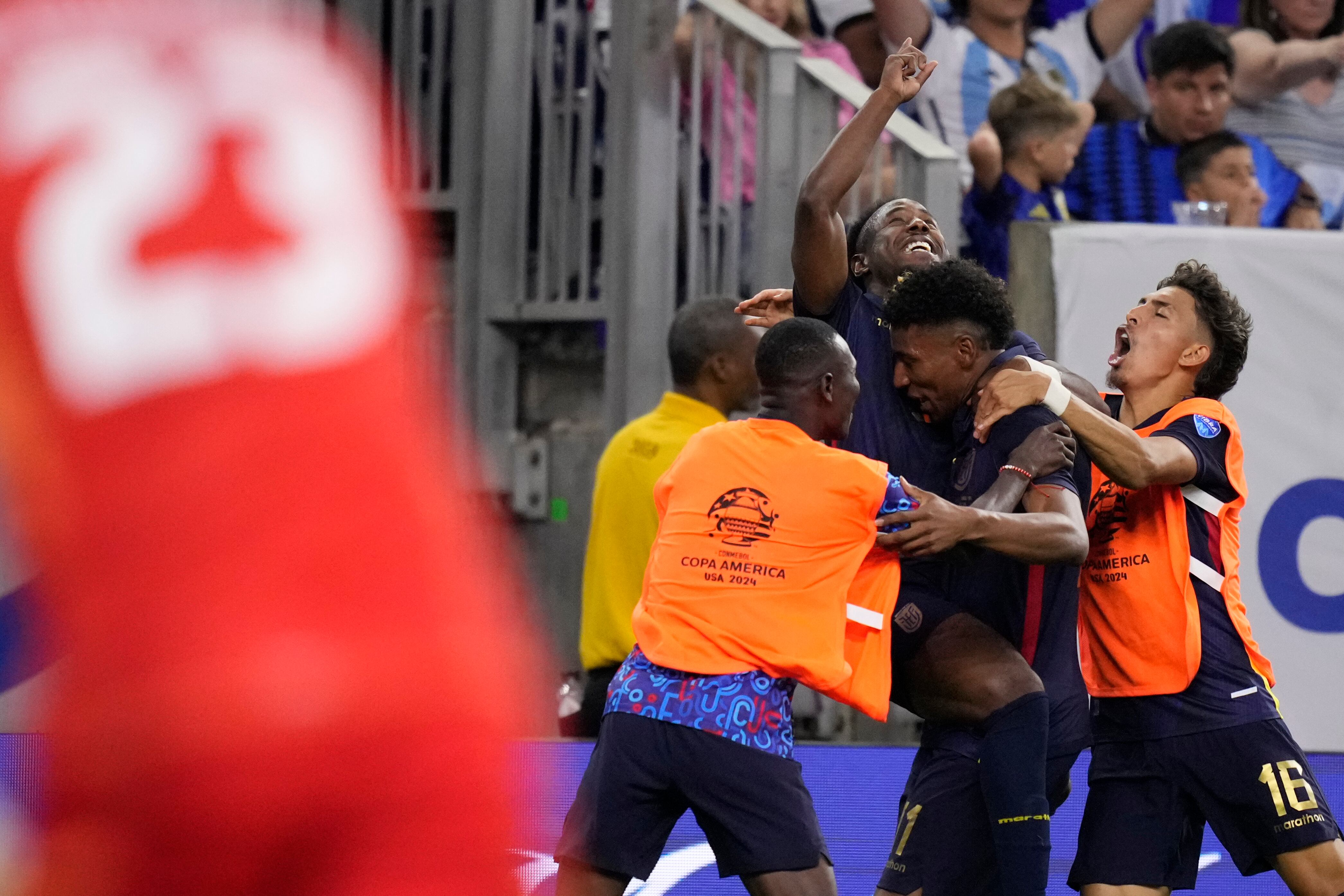 Ecuador's Kevin Rodriguez, center, celebrates scoring his side's first goal against Argentina with teammates during a Copa America quarterfinal soccer match in Houston, Thursday, July 4, 2024. . (AP Photo/Kevin M. Cox)