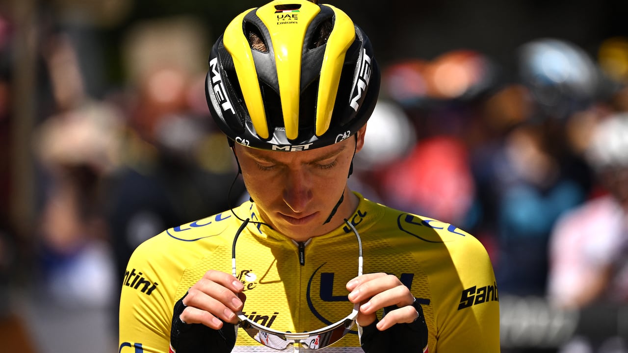 UAE Team Emirates team's Slovenian rider Tadej Pogacar wearing the overall leader's yellow jersey adjusts his glasses as he awaits the start of the 10th stage of the 109th edition of the Tour de France cycling race, 148,1 km between Morzine and Megeve, in the French Alps, on July 12, 2022. (Photo by Marco BERTORELLO / AFP)