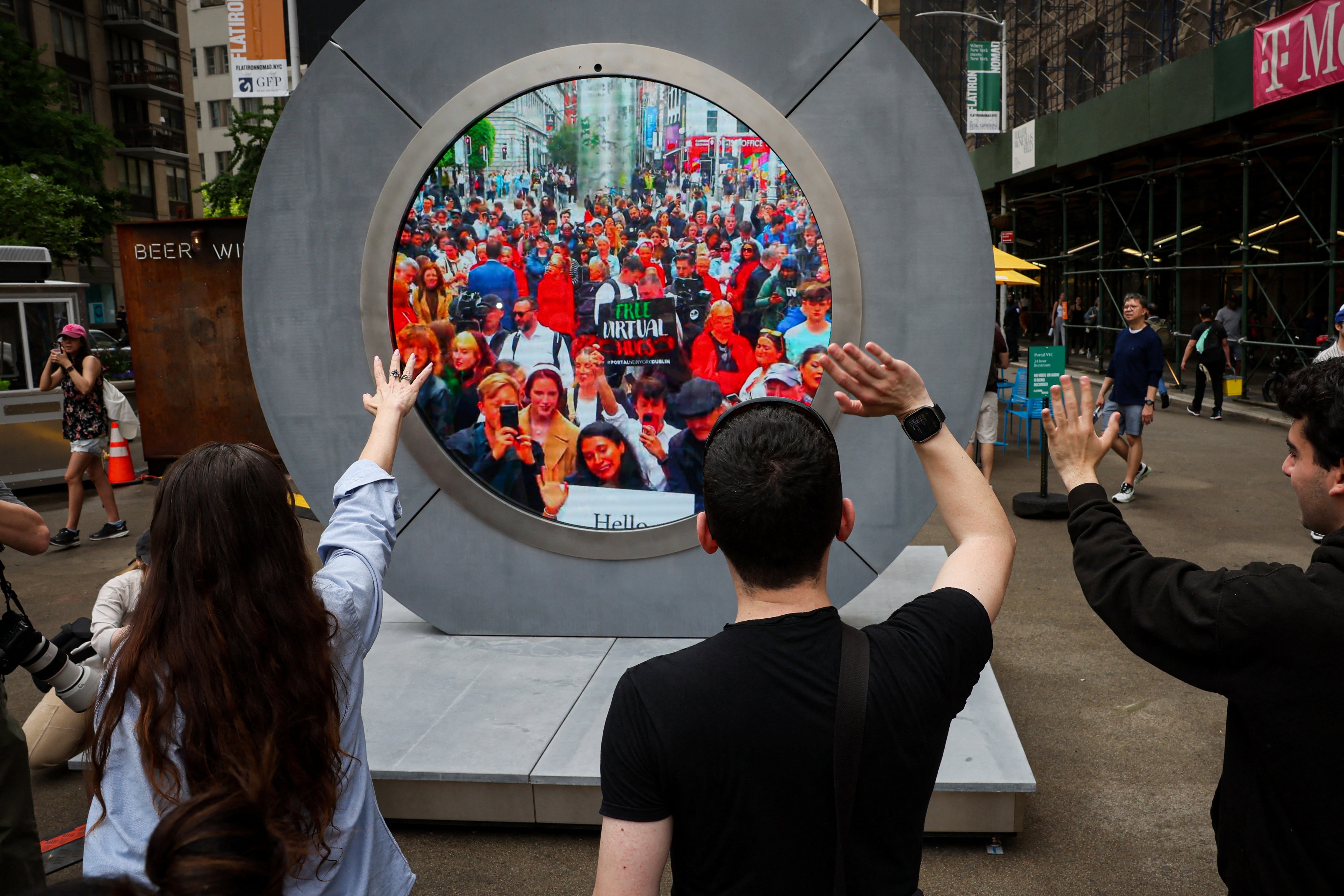 Los neoyorquinos saludan a la gente en Dublín durante la revelación del Portal, una escultura de tecnología pública que conecta directamente entre Dublín, Irlanda y el distrito Flatiron en Manhattan, en la ciudad de Nueva York, EE.UU., 8 de mayo de 2024.