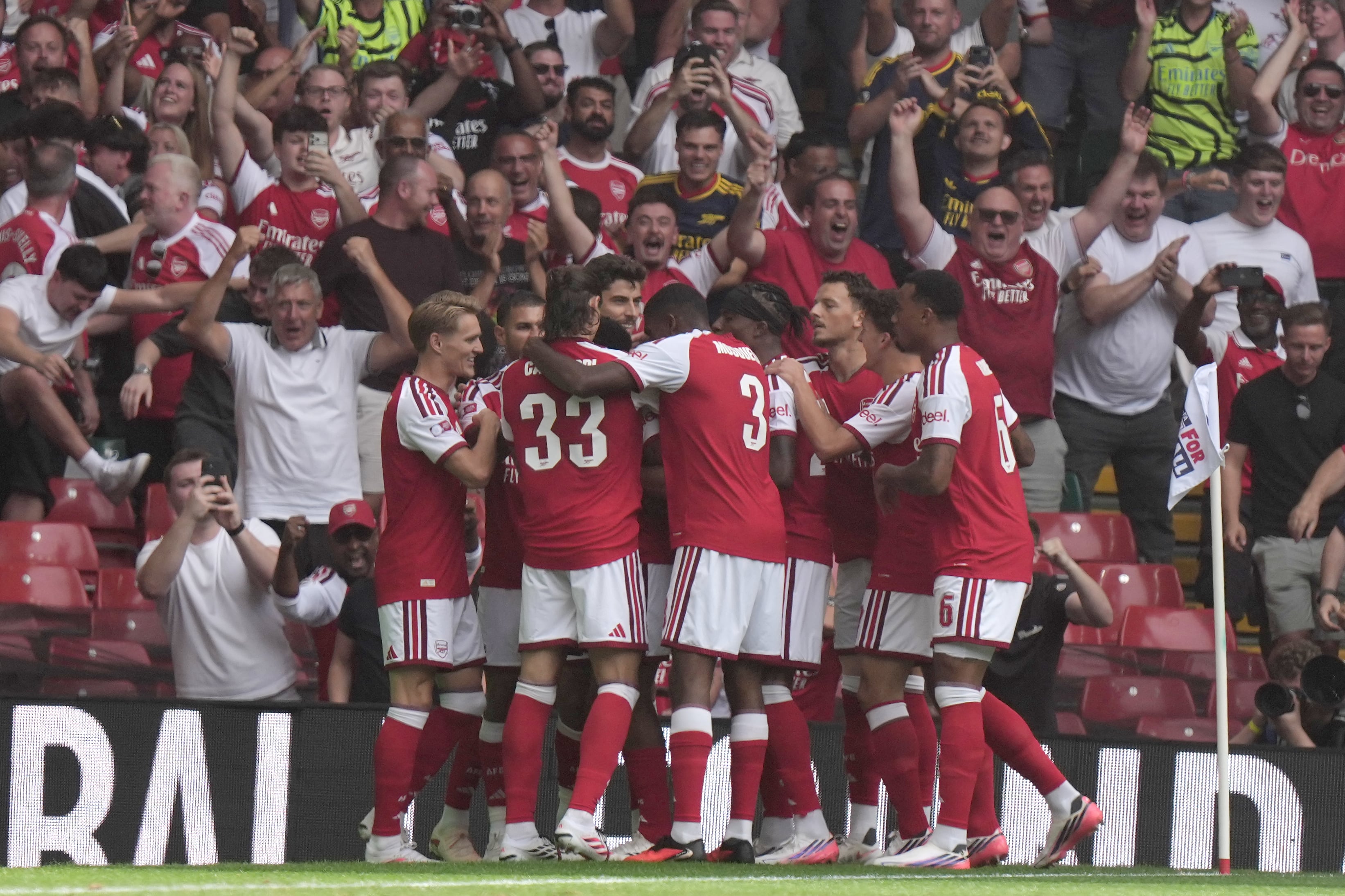 Arsenal's Riccardo Calafiori celebrates with teammates after scoring the opening goal during the FA Community Shield final soccer match between Arsenal and Manchester City in Cardiff, Wales, Sunday, Aug.16, 2026. (AP Photo/Alastair Grant)