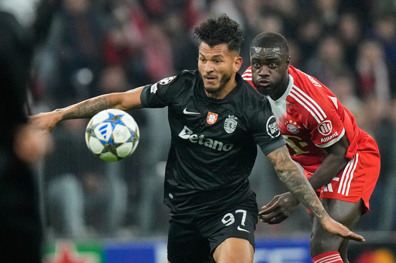 Bayern's Dayot Upamecano, right, challenges for the ball with Sporting's Luis Suarez during the Champions League opening phase soccer match between FC Bayern Munich and Sporting CP in Munich, Germany, Tuesday, Dec. 9, 2025. (AP Photo/Matthias Schrader)