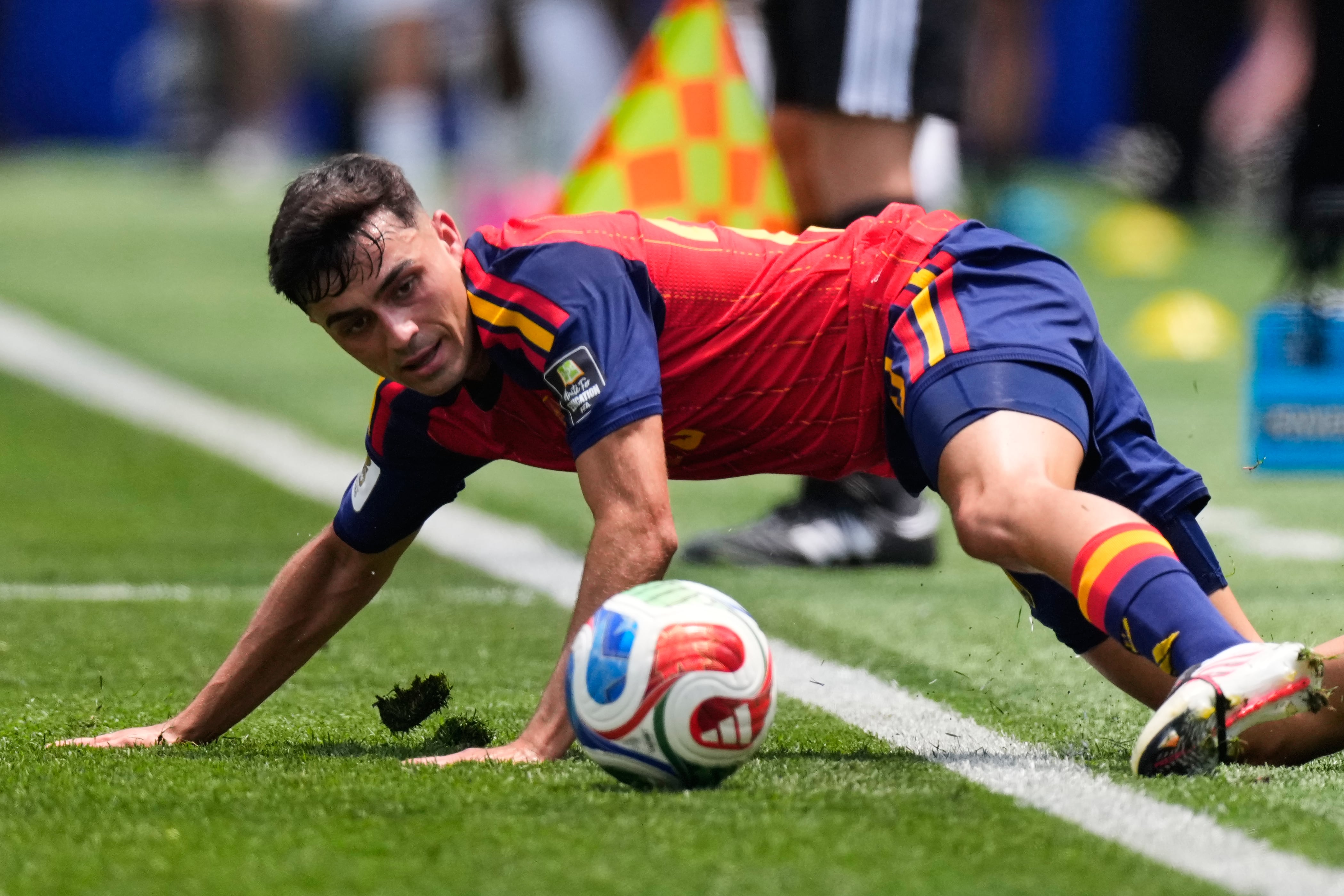 Spain's Pedri (20) attempts to keep the ball on the pitch during the World Cup quarterfinal soccer match between Spain and Belgium in Inglewood, Calif., near Los Angeles, Friday, July 10, 2026. (AP Photo/Mark J. Terrill)