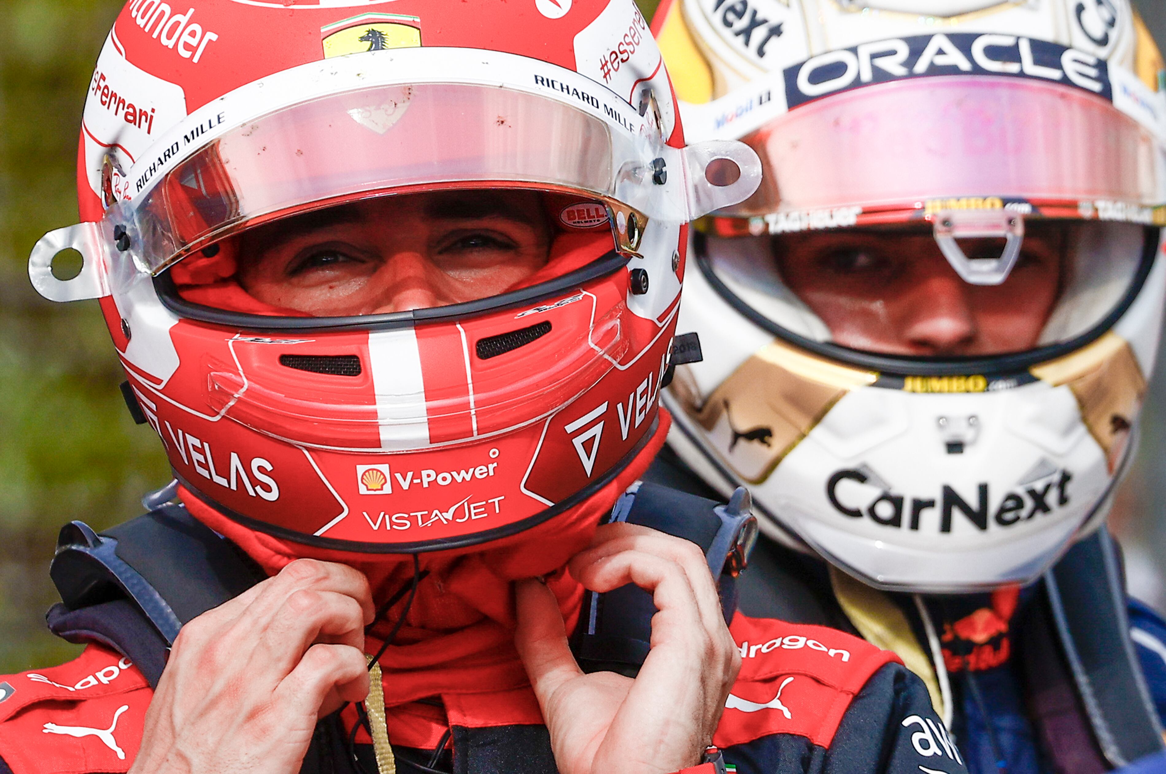 Ferrari driver Charles Leclerc of Monaco, left, walks past Red Bull driver Max Verstappen of the Netherlands after they respectively clocked the second and first fastest time during a sprint race at the Enzo and Dino Ferrari racetrack, in Imola, Italy, Saturday, April 23, 2022. The Italy's Emila Romagna Formula One Grand Prix will be held on Sunday.(Guglielmo Mangiapane, Pool via AP)
