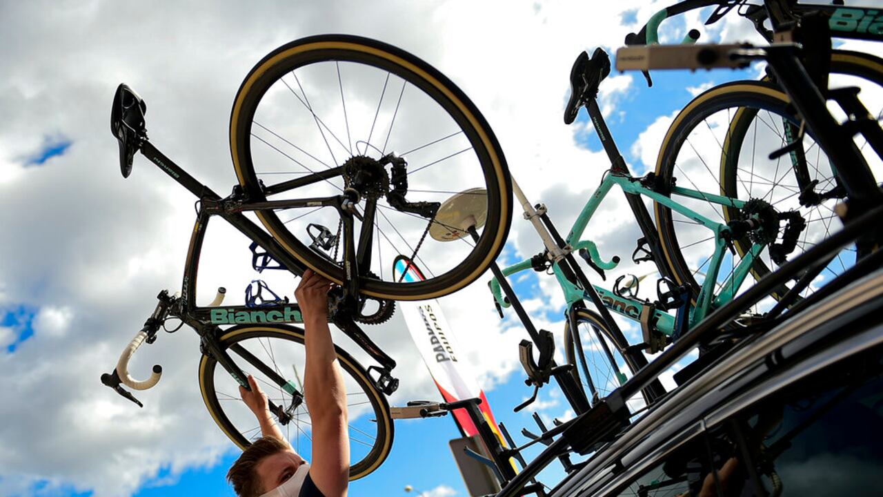A Jumbo staff member holds up the bicycle of Primoz Roglic before the second stage of La Vuelta between Pamplona and Lekunberri, in Pamplona, northern Spain, Wednesday, Oct. 21, 2020. (AP Photo/Alvaro Barrientos)
