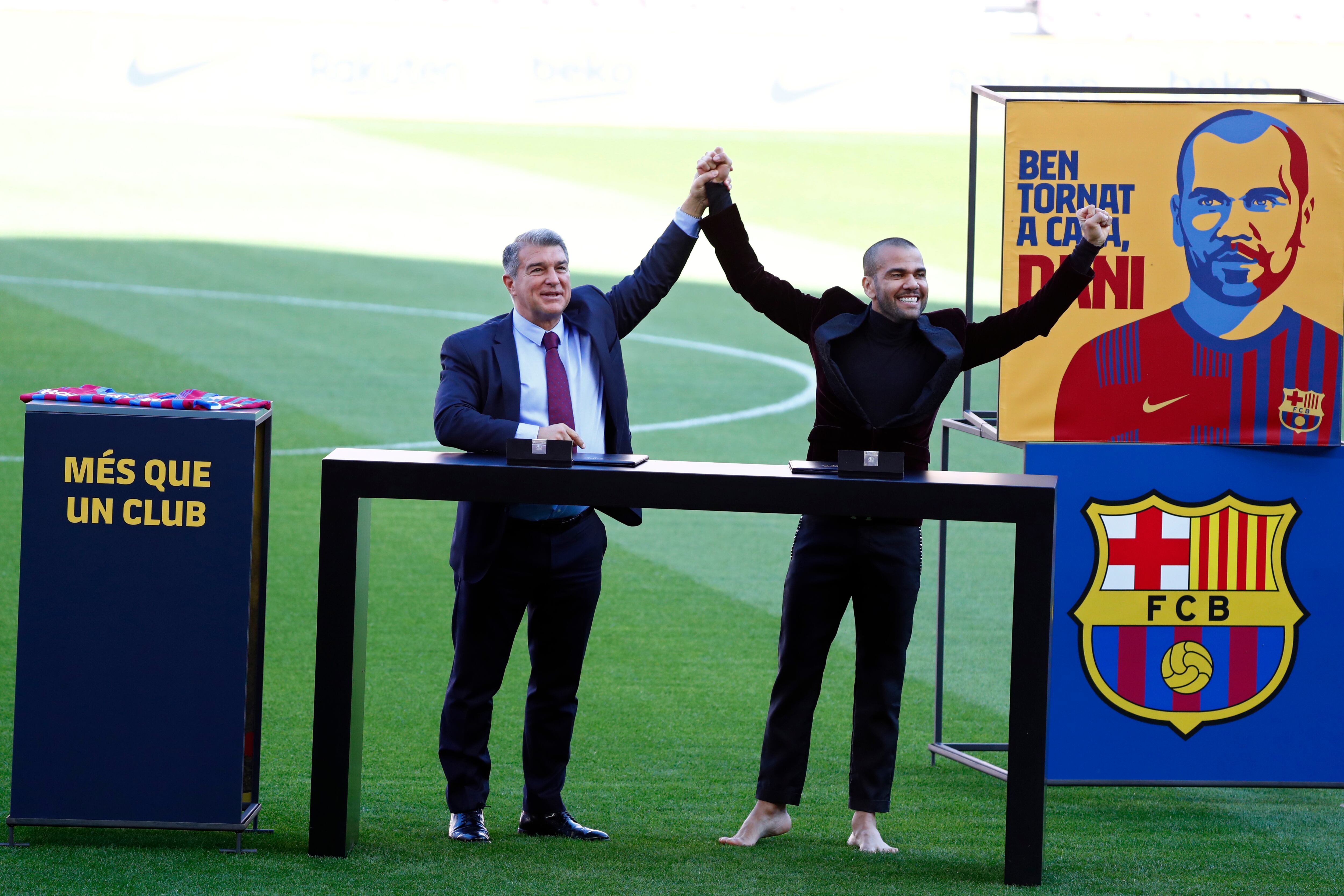 Dani Alves, right and Barcelona club President Joan Laporta react during Alves' official presentation for FC Barcelona in Barcelona, Spain, Wednesday, Nov. 17, 2021. Veteran full back Dani Alves has returned to Barcelona at age 38 to finish out the rest of the season with the team. Alves formed part of Barcelona's greatest era from 2008 to 2016 and helped it win 23 titles, including three Champions League trophies and six Spanish leagues.(AP Photo/Joan Monfort)