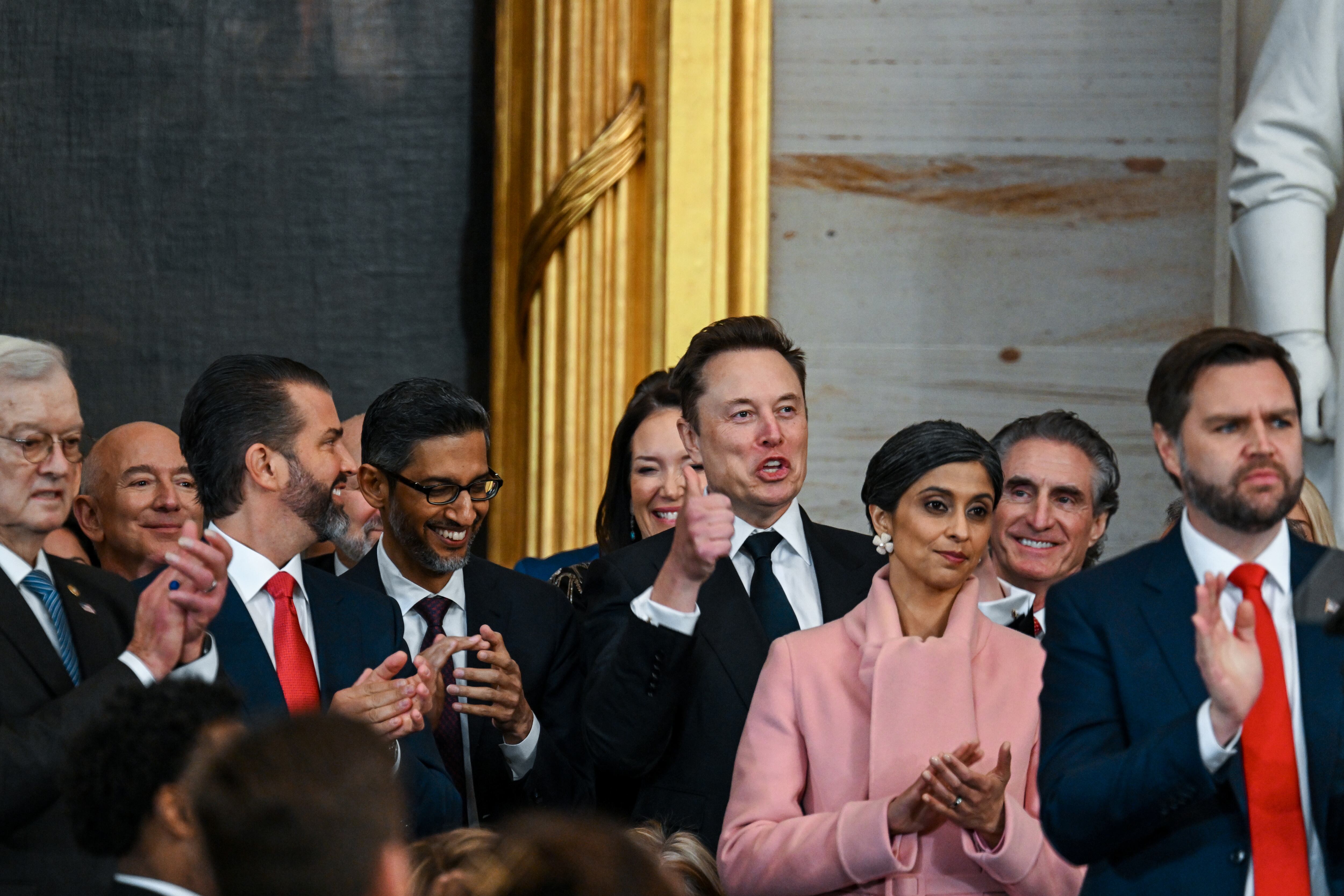 WASHINGTON, DC - JANUARY 20: Amazon founder Jeff Bezos, Donald Trump Jr., Google CEO Sundar Pichai, Tesla CEO Elon Musk, Usha Vance, Interior Secretary nominee Doug Burgum and Vice President-elect JD Vance applaud during the inauguration of U.S. President-elect Donald Trump in the U.S. Capitol Rotunda on January 20, 2025 in Washington, DC. Donald Trump takes office for his second term as the 47th President of the United States. (Photo by Kenny Holston-Pool/Getty Images)