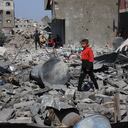 Palestinian youths salvage items from the destroyed house of the Qrayqea family in the Shujaiya district in eastern Gaza City on March 18, 2025 following Israeli strikes at dawn. Israel on March 18 unleashed its most intense strikes on the Gaza Strip since a January ceasefire, with Gaza's health ministry saying their toll rose to 413 people killed, and the Palestinian Hamas movement accusing Israel's premier of deciding to "resume war" after a deadlock on extending the truce. (Photo by Omar AL-QATTAA / AFP)