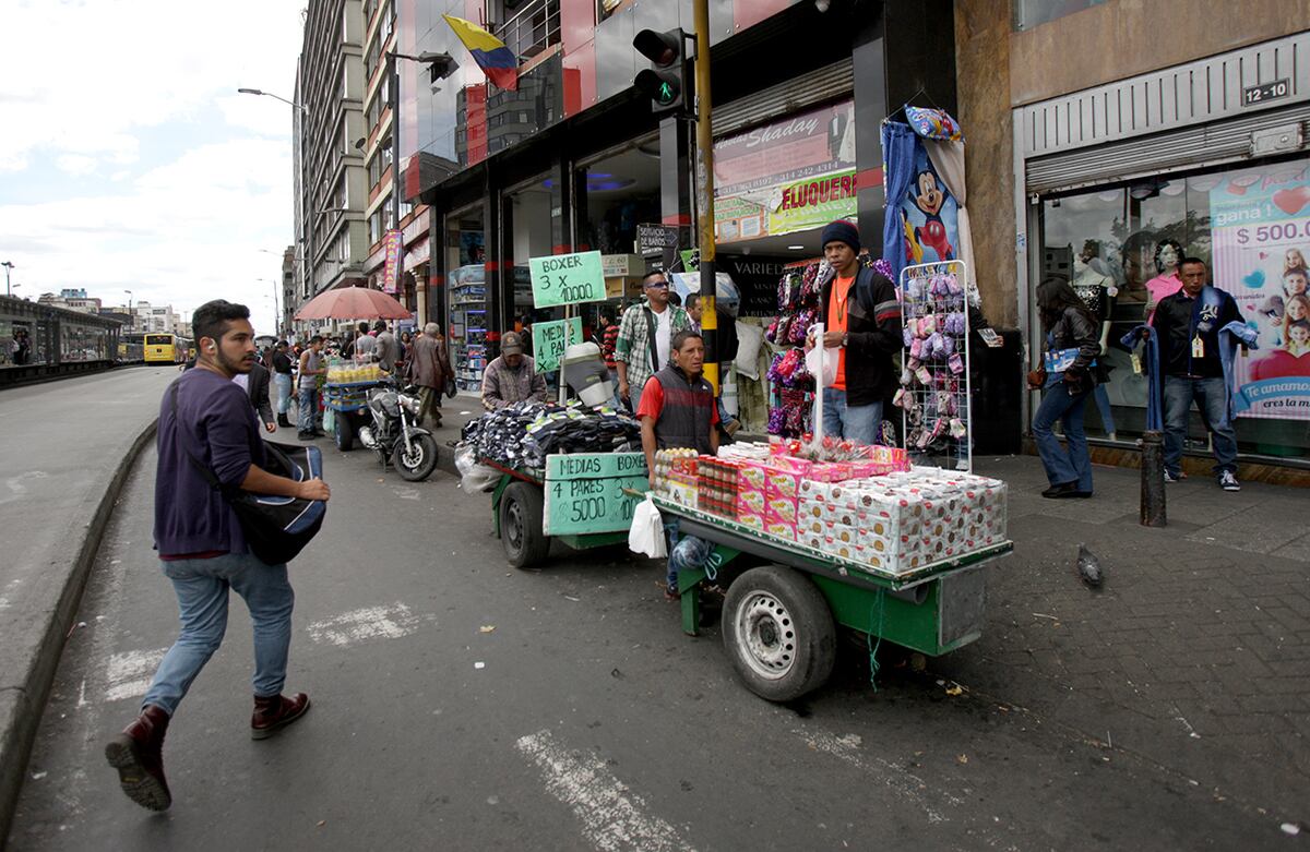 Los vendedores ambulantes también invaden las calles por donde se movilizan los carros.