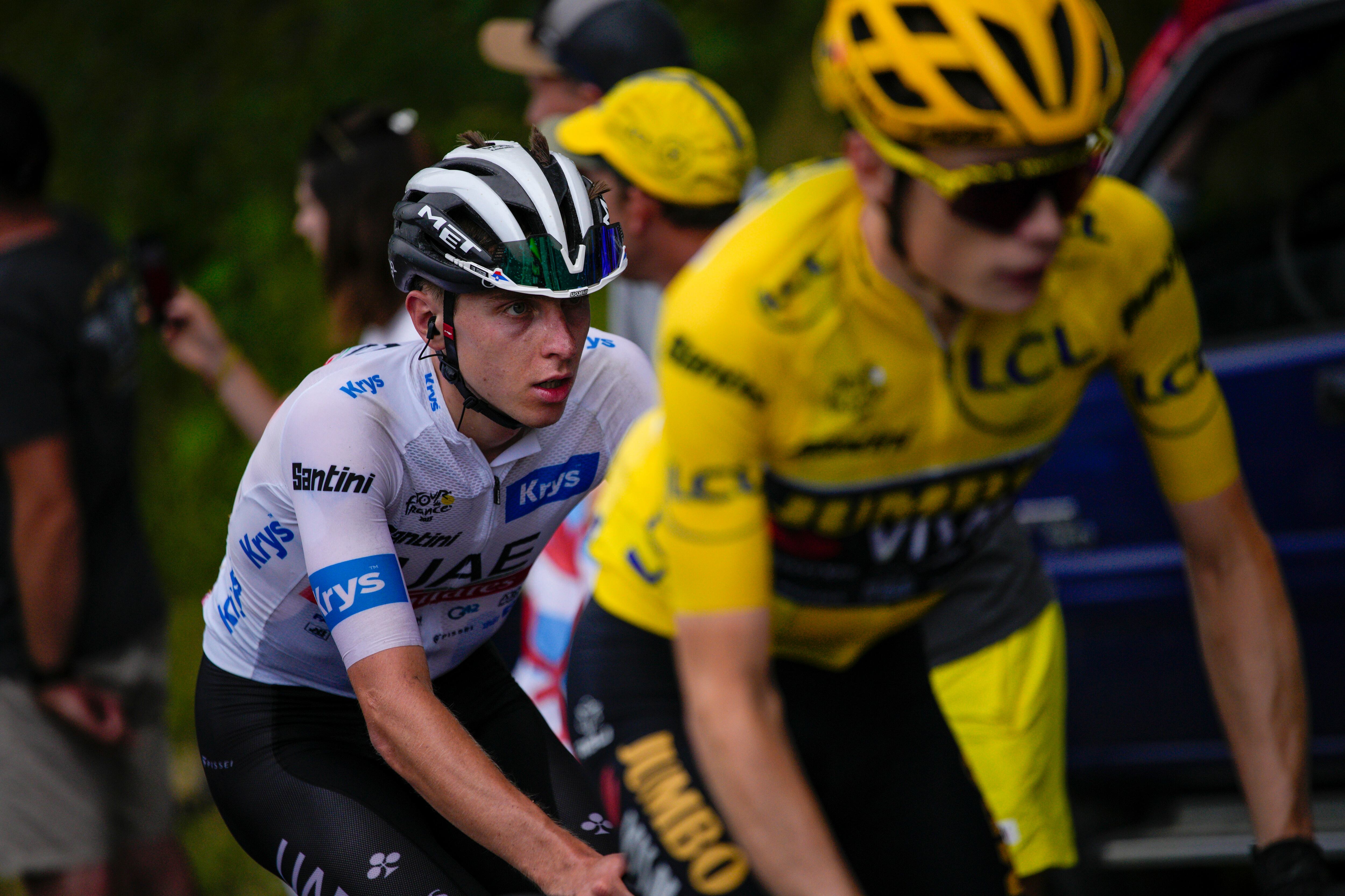 Slovenia's Tadej Pogacar, wearing the best young rider's white jersey, follows Denmark's Jonas Vingegaard, wearing the overall leader's yellow jersey, during the seventeenth stage of the Tour de France cycling race over 166 kilometers (103 miles) with start in Saint-Gervais Mont-Blanc and finish in Courchevel, France, Wednesday, July 19, 2023. (AP Photo/Daniel Cole)