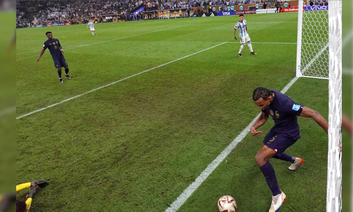Soccer Football - FIFA World Cup Qatar 2022 - Final - Argentina v France - Lusail Stadium, Lusail, Qatar - December 18, 2022 Argentina's Lionel Messi scores their third goal as France's Jules Kounde looks on Pool via REUTERS/Lars Baron