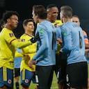 Uruguay and Colombia players argue with each other during a qualifying soccer match for the FIFA World Cup Qatar 2022 in Montevideo, Uruguay, Thursday, Oct. 7, 2021. (Andres Cuenca/Pool via AP)