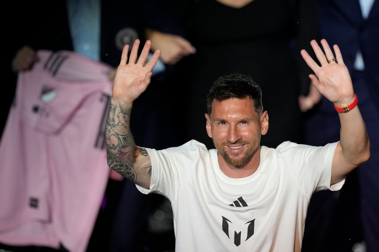 CORRECTS STADIUM NAME - Inter Miami's Lionel Messi waves after receiving his team jersey as he is introduced during a celebration by the team at DRV PNK Stadium, Sunday, July 16, 2023, in Fort Lauderdale, Fla. (AP Photo/Rebecca Blackwell)