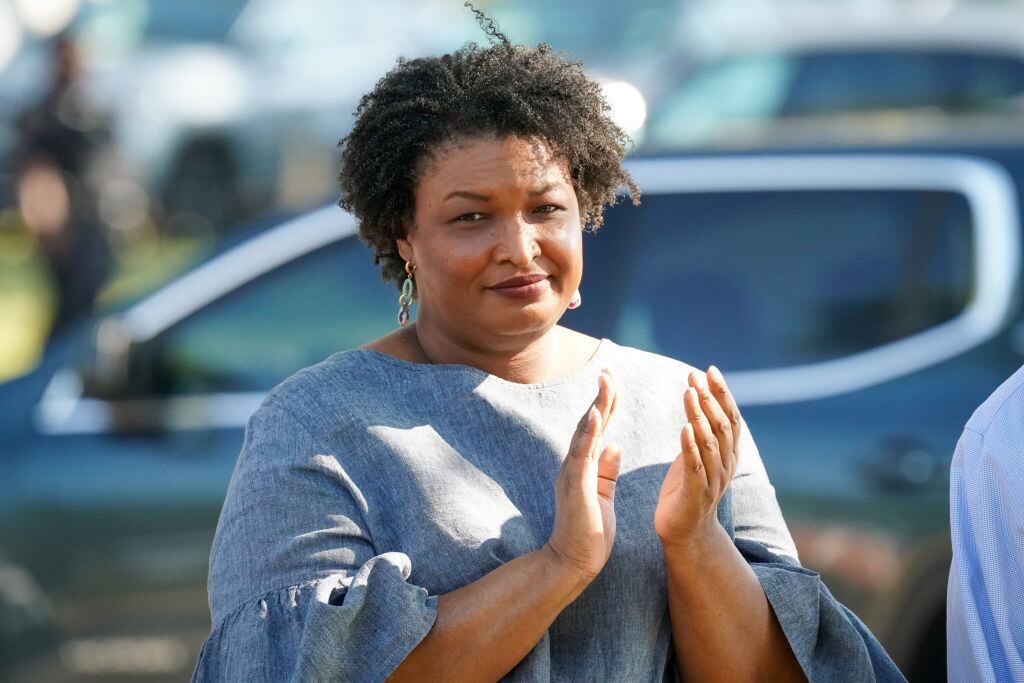 FORT VALLEY, GEORGIA - OCTOBER 13: Former Georgia House Rep. Stacey Abrams applauds comments by former President Bill Clinton during the Fort Valley GOTV Community Fish Fry at the Agricultural Technology Conference Center on October 13, 2024 in Fort Valley, Georgia. With 22 days until the election, recent polls in Georgia show that Republican presidential nominee, former President Donald Trump leads his opponent Democratic presidential nominee, Vice President Kamala Harris by one point. (Photo by Julia Beverly/Getty Images)