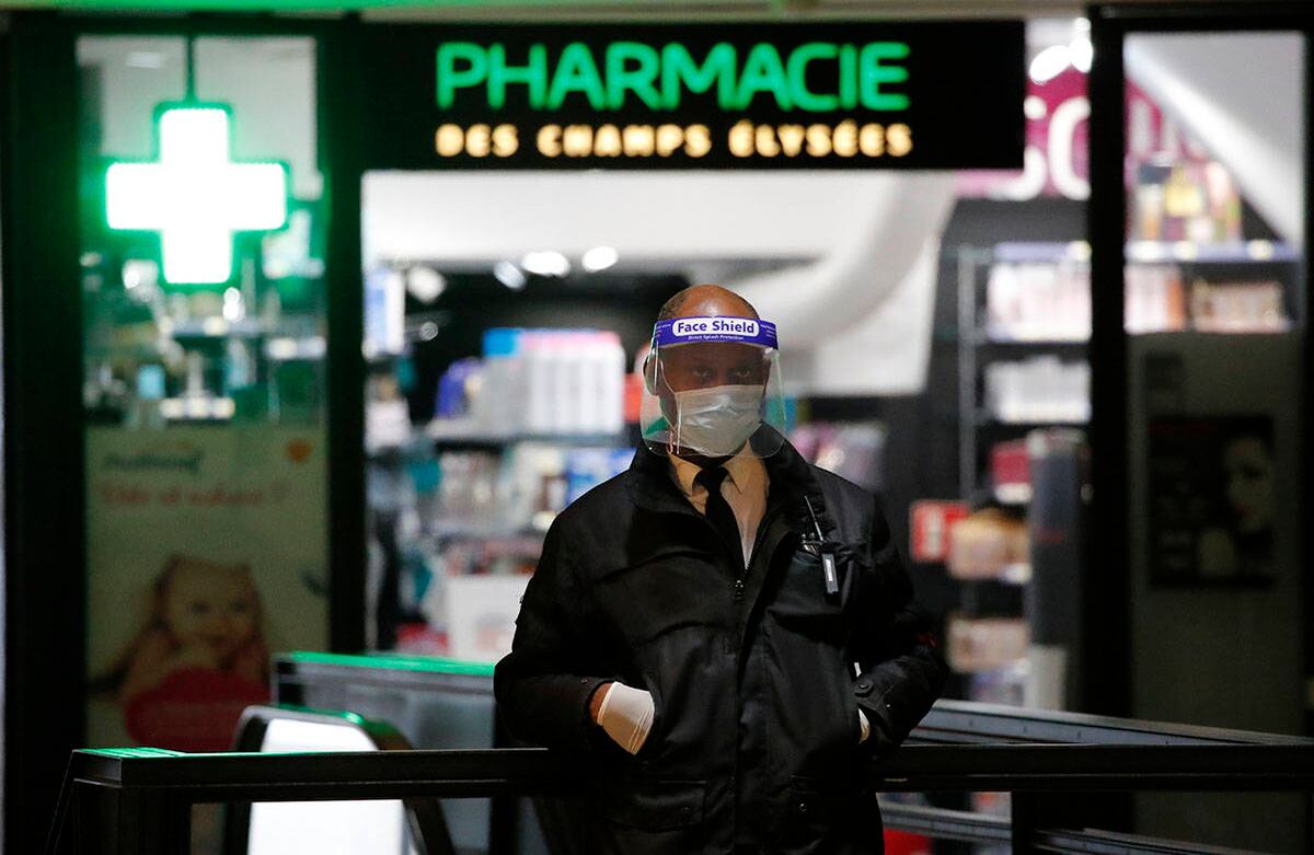 Un oficial de seguridad con un protector facial y guantes se encuentra frente a una farmacia el lunes, 11 de mayo de 2020 en París. Foto: Francois Mori/AP
