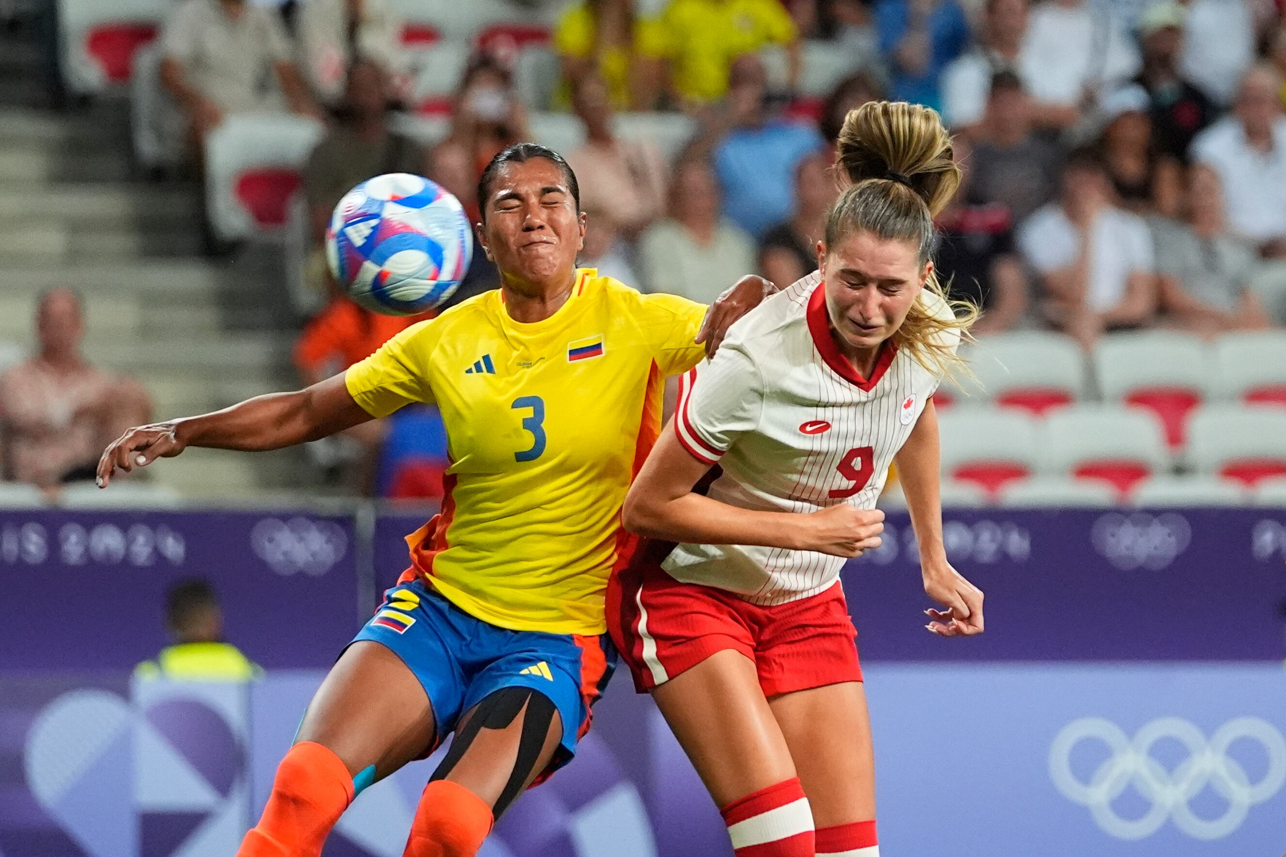 Canada's Jordyn Huitema, right, heads the ball past Colombia's Daniela Arias during a women's Group A soccer match between Colombia and Canada, at the 2024 Summer Olympics, Wednesday, July 31, 2024, at the Nice Stadium in Nice, France. (AP Photo/Julio Cortez)