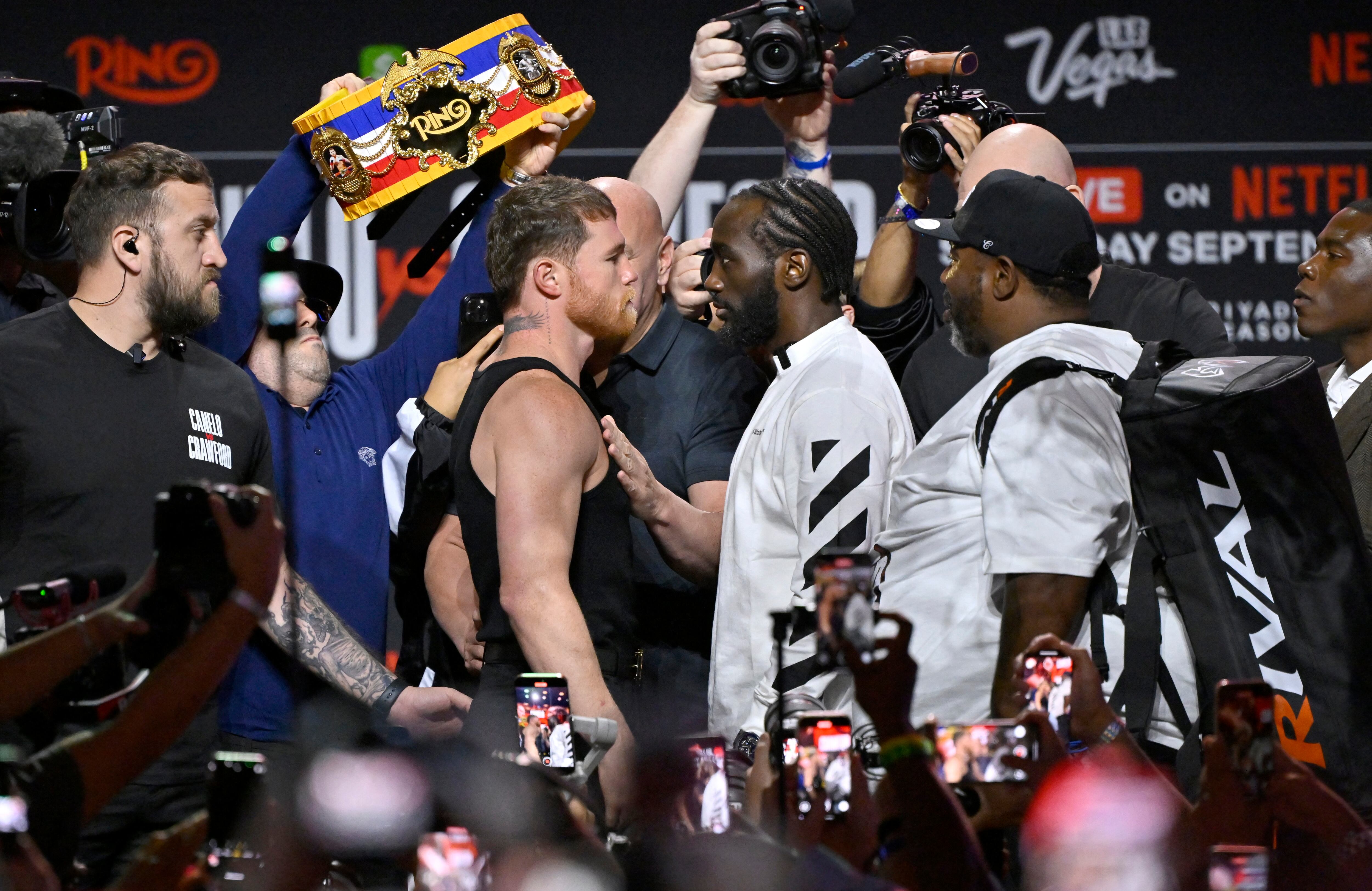 LAS VEGAS, NEVADA - SEPTEMBER 11: Canelo �lvarez (L) and Terence Crawford (R) face off onstage during Netflix's Canelo vs Crawford press conference at T-Mobile Arena on September 11, 2025 in Las Vegas, Nevada.   David Becker/Getty Images for Netflix/AFP (Photo by David Becker / GETTY IMAGES NORTH AMERICA / Getty Images via AFP)