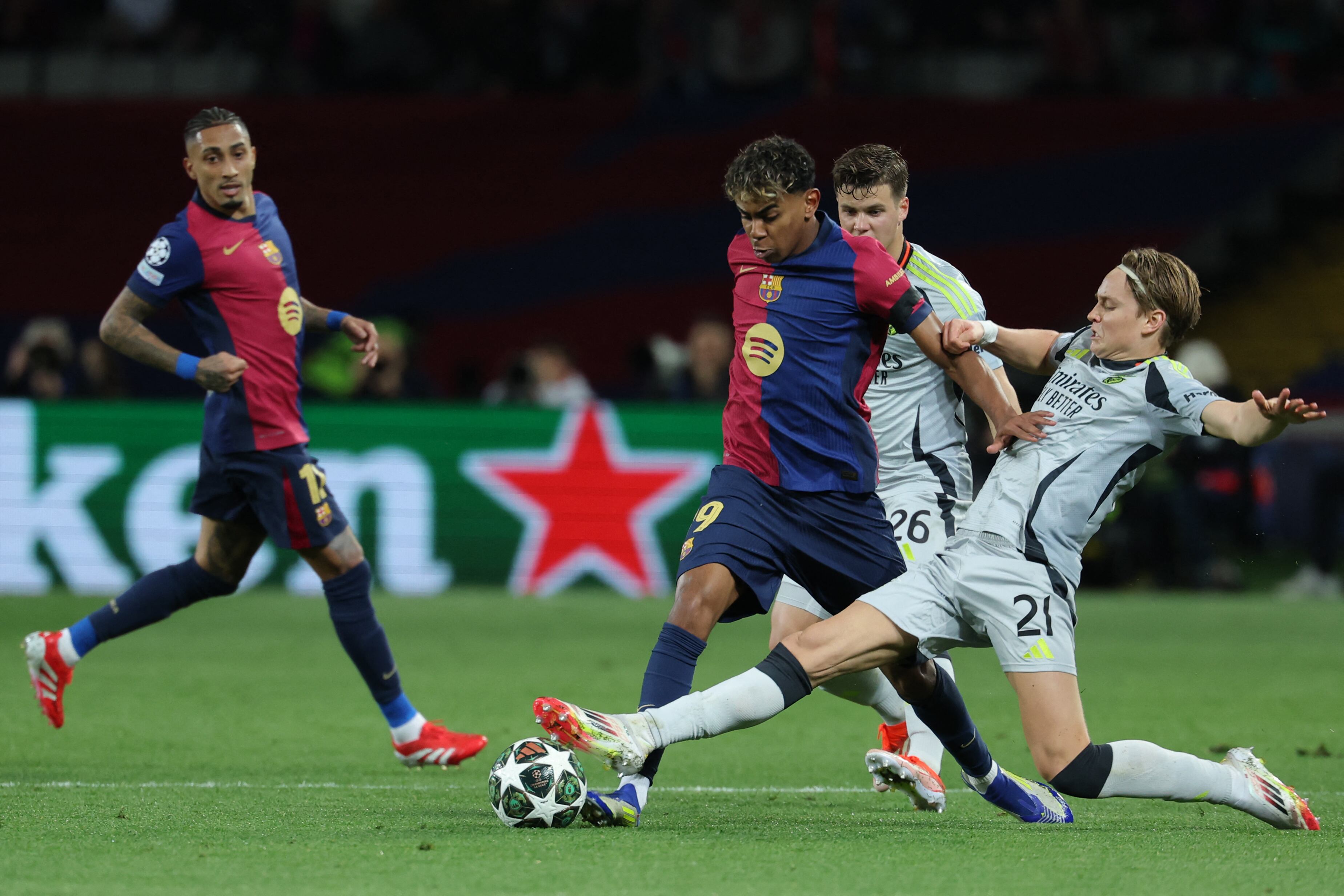 Benfica's Norwegian forward #21 Andreas Schjelderup tackles Barcelona's Spanish forward #19 Lamine Yamal during the UEFA Champions League Round of 16 second leg football match between FC Barcelona and SL Benfica at the Estadi Olimpic Lluis Companys in Barcelona on March 11, 2025. (Photo by LLUIS GENE / AFP)