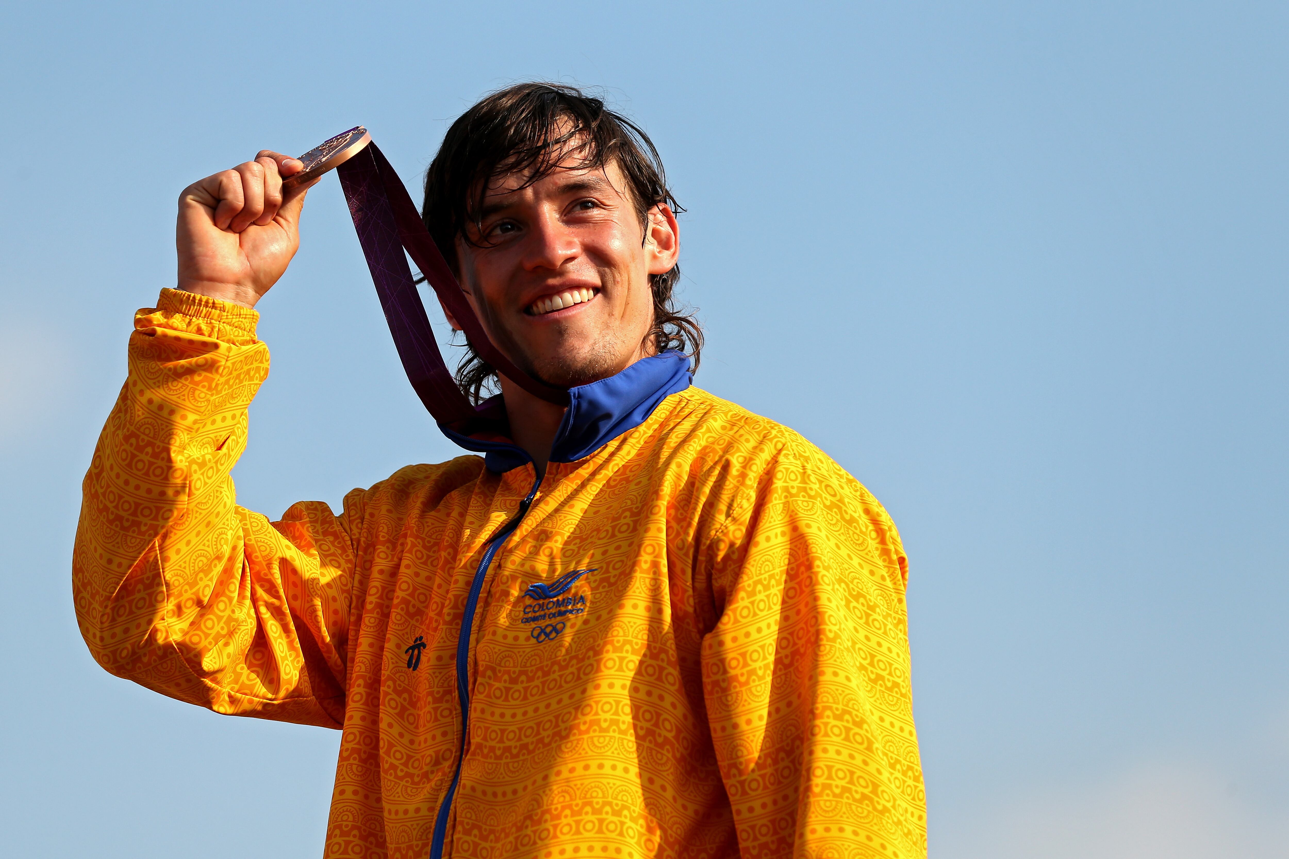 LONDON, ENGLAND - AUGUST 10:  Bronze medallist Carlos Mario Oquendo Zabala of Colombia celebrate during the medal ceremony for the Men's BMX Cycling Final on Day 14 of the London 2012 Olympic Games at the BMX Track on August 10, 2012 in London, England.  (Photo by Bryn Lennon/Getty Images)
