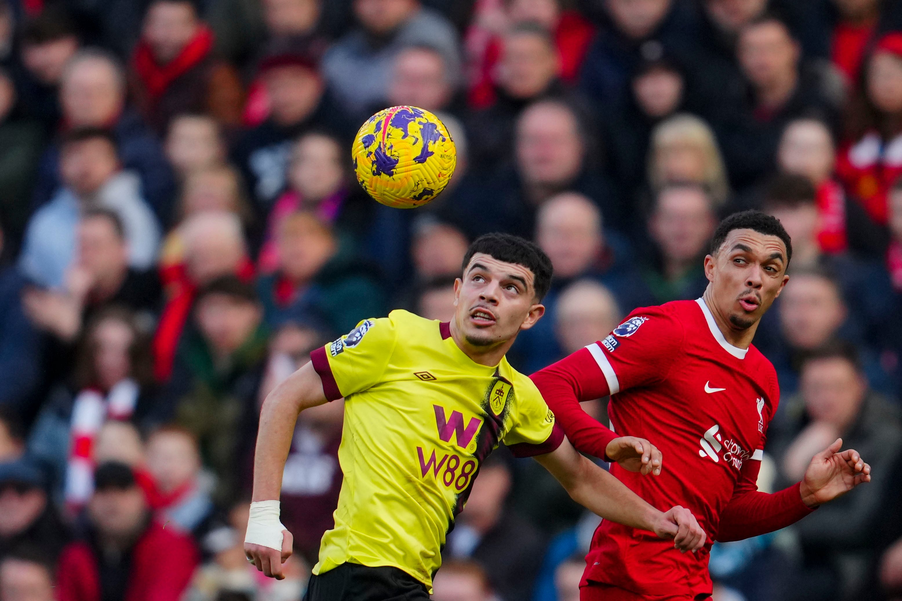 Burnley's Zeki Amdouni, left, duels for the ball with Liverpool's Trent Alexander-Arnold during the English Premier League soccer match between Liverpool and Burnley, at Anfield stadium in Liverpool, England, Saturday, Feb. 10, 2024. (AP Photo/Jon Super)