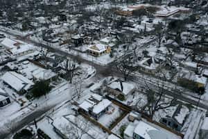 Snow and ice grips a neighborhood in East Austin on Tuesday, Feb. 16, 2021. Day six of the statewide freeze and still millions of Texans are without power. (Bronte Wittpenn /Austin American-Statesman via AP)