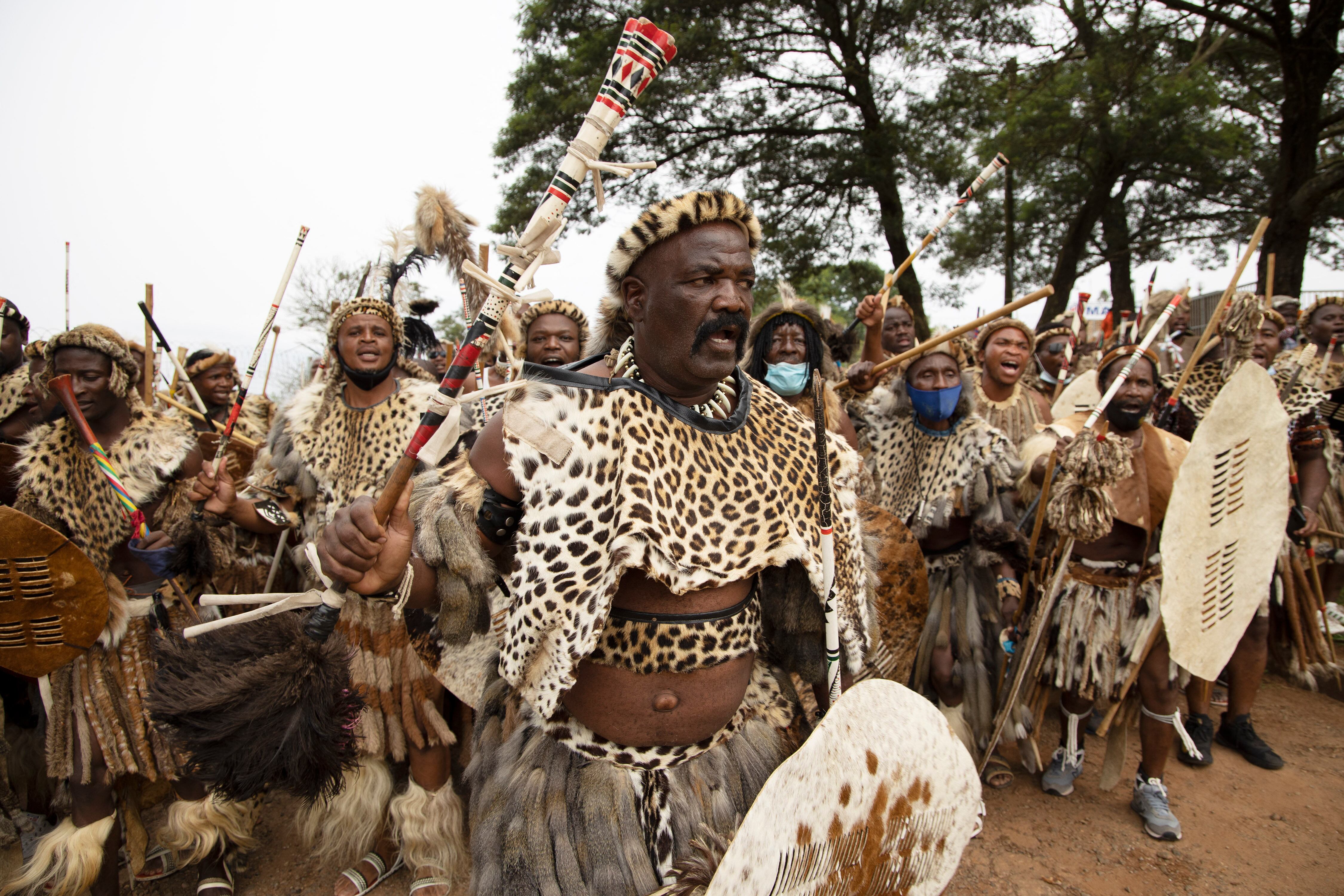 Amabutho (Zulu regiments) make their way to the mortuary to receive the body of King Goodwill Zwelithini from in Nongoma, KwaZulu Natal on March 17, 2021. - King Goodwill Zwelithini died on March 12, 2021 in the eastern city of Durban, aged 72, after weeks of treatment for a diabetes-related illness.
