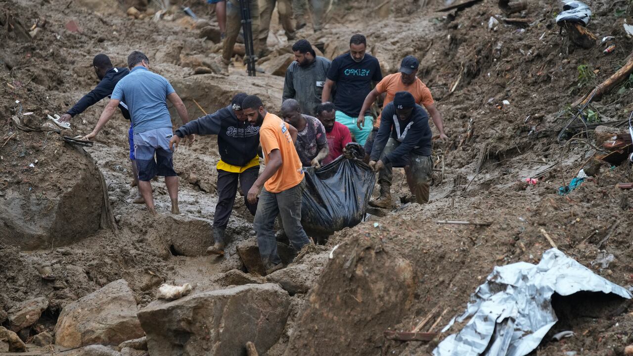 Residentes y voluntarios recuperan el cuerpo de una persona fallecida en un deslave, en Petrópolis, Brasil, el 16 de febrero de 2022.