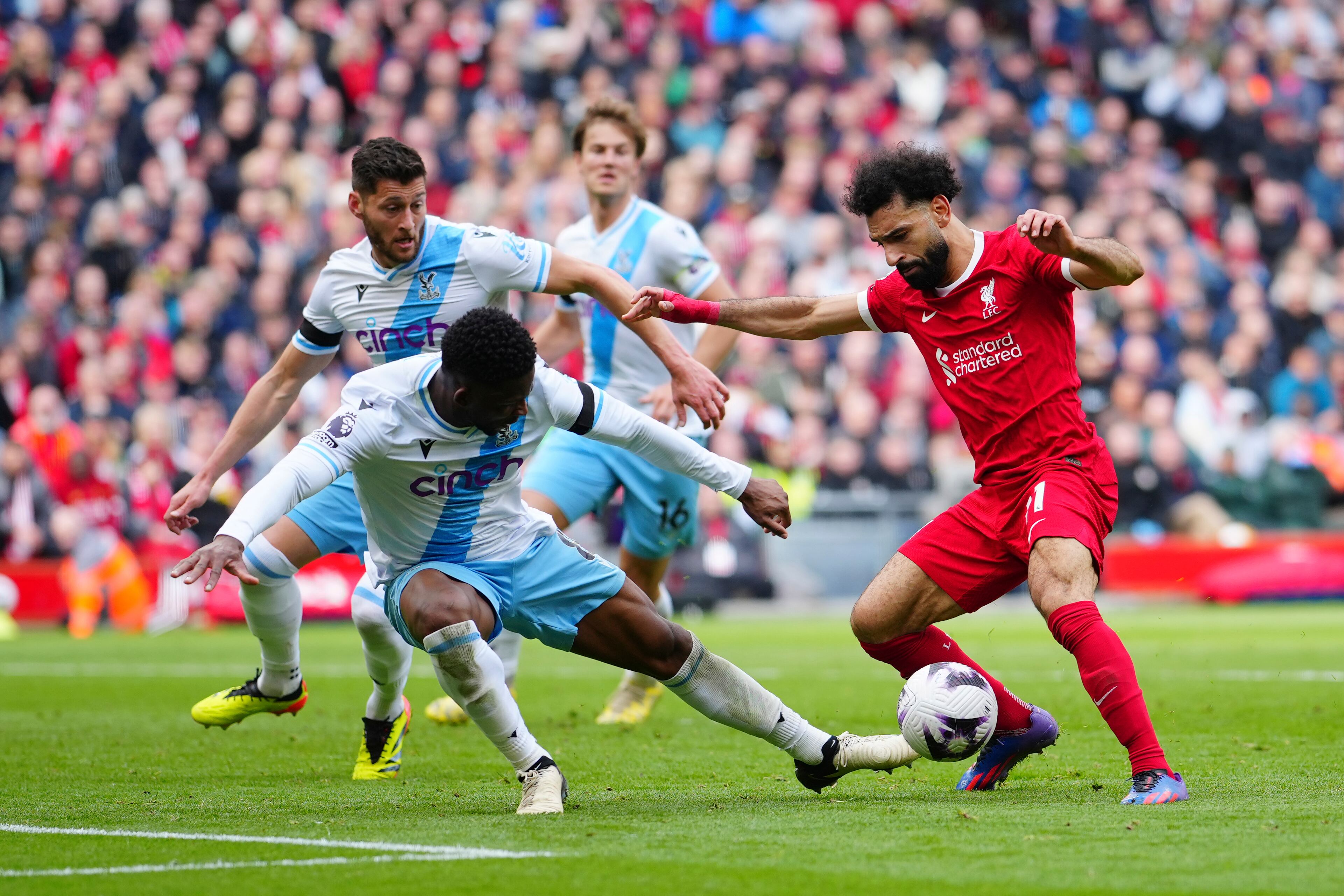 Liverpool's Mohamed Salah, right, challenges for the ball with Crystal Palace's Jefferson Lerma during the English Premier League soccer match between Liverpool and Crystal Palace at Anfield Stadium in Liverpool, England, Sunday, April 14, 2024. (AP Photo/Jon Super)