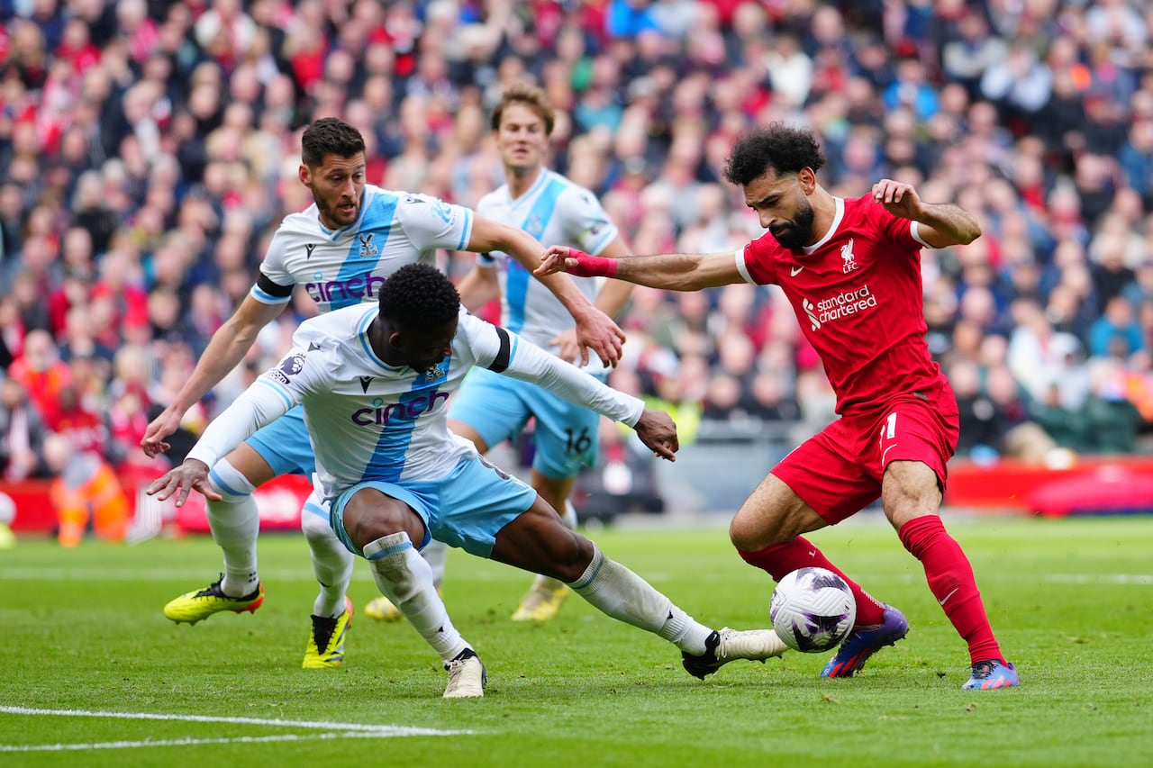 Liverpool's Mohamed Salah, right, challenges for the ball with Crystal Palace's Jefferson Lerma during the English Premier League soccer match between Liverpool and Crystal Palace at Anfield Stadium in Liverpool, England, Sunday, April 14, 2024. (AP Photo/Jon Super)